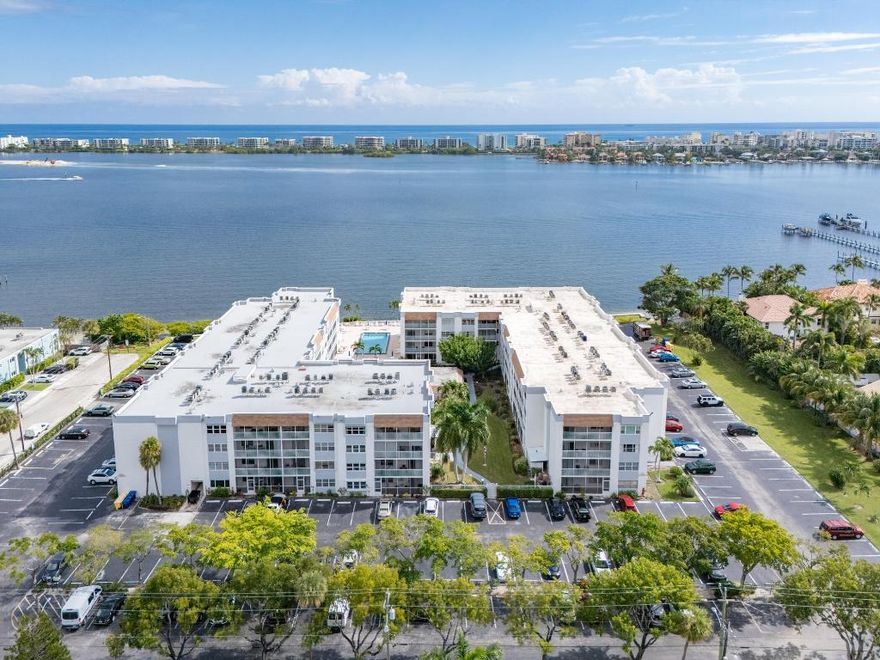 Enjoy the beautiful views from this waterfront-community 2 bedroom 2-bath top-floor condo that's been carefully updated with hurricane impact windows & sliders throughout.  Handsome kitchen with granite countertops & newer cabinets opens to the dining area & living room for entertaining. Large master bedroom has walk-in closets & hurricane sliders that provide plenty of light & lead to the large screened in balcony. Second bedroom features a comfortable Murphy bed for overnight guests & doubles as an office/den. Community offers a beautiful heated pool overlooking the Intracoastal, BBQ grill, same-floor laundry facilities & clubhouse with pool table and full kitchen. HOA fee includes basic cable & water. Great location near Downtown Lake Worth Beach with plenty of shopping & restaurants.