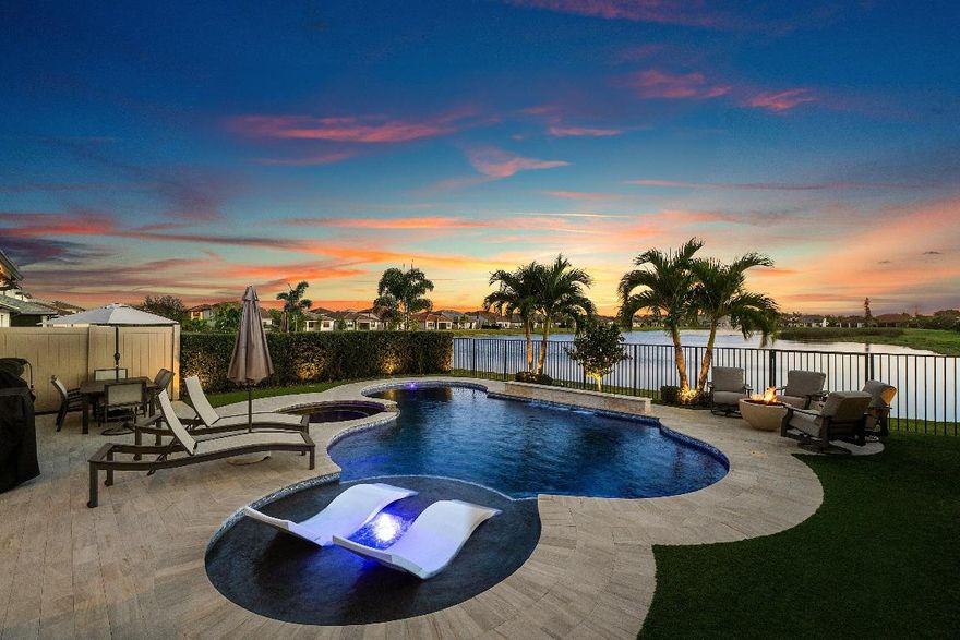 Welcome home to this beautifully updated 3-bedroom, 2.5-bath residence with den, loft, and two-car garage, located in the desirable gated community of The Fields. Built by DiVosta, this sought-after Fifth Avenue model showcases some of the best lake views in the neighborhood and offers an ideal blend of luxury, functionality, and thoughtful modern upgrades, with the added flexibility and potential to convert to a 4-bedroom to suit a buyer's needs.

Curb appeal is immediate with manicured landscaping, a brick paver driveway, and brick-accented entry pillars that set the tone for the home's refined design. The outdoor living space is exceptional, featuring a heated saltwater pool and spa with top-of-the-line Jandy equipment, clean ledge waterfall, sundeck with bubbler, five newly replaced color-changing LED lights, and full automation. The fully fenced backyard is finished with marble pool decking and professionally installed turf, complemented by a built-in natural gas firepit, upgraded front and rear landscaping, and a complete remote-controlled color-changing landscape lighting system with tree spotlights, walkway lighting, and hidden well lights.

Additional exterior and mechanical upgrades include a whole-home water filtration system, pre-wiring for Level II EV charging, a new AC compressor installed in November 2025, Ring Pro doorbell, and the latest-generation Nest thermostat. The garage is equally well-appointed with painted walls, epoxy flooring, and two large ceiling-mounted storage racks.

Inside, the open-concept floor plan showcases vertically laid wood-look tile flooring, recessed lighting throughout, updated trim, fresh custom paint including all doors, and upgraded fixtures. Interior enhancements include custom door and cabinet hardware, upgraded solid wood 9-foot doors, a custom glass impact front door, decorative wall paneling in the living room, a custom accent wall in the primary bedroom, and a chalk wall in bedroom two. Lighting upgrades include adjustable warm-to-bright recessed lighting, color-changing lighting in the second and third bedrooms, upgraded fixtures in the mudroom and primary suite, LED-lit outlets with integrated dimmable nightlights, and high-end remote-controlled Dan's ceiling fans throughout.

The kitchen is beautifully appointed with a massive quartz island, tile backsplash, bar-top seating, pendant lighting, oversized sink with disposal and filtered water spout, solid wood shaker cabinetry with modern hardware, and stainless steel appliances including a gas range, Samsung Bespoke color-matched refrigerator, wine fridge, and custom pantry. Peaceful pool and lake views complete the space.

The living and dining areas flow seamlessly from the kitchen, offering abundant natural light and tranquil lake and pool views. Just off the entryway is a private den with tray ceiling, recessed lighting, and freshly painted French doors, along with a conveniently located half bath featuring updated fixtures and trim. An additional downstairs flex space with sliding glass doors offers the perfect option for a mudroom or home office.

The spacious primary suite features a tray ceiling, recessed lighting, custom accent wall, impact windows, and serene backyard and lake views. The en suite bath includes a dual-sink quartz vanity with solid wood cabinetry, updated fixtures and mirrors, a fully tiled walk-in shower with frameless glass and niche shelving, and an oversized Roman soaking tub with updated hardware and chandelier. A large walk-in closet with custom built-ins completes the suite.

Upstairs, both secondary bedrooms offer tall ceilings, multiple impact windows, walk-in closets, and abundant natural light. The secondary bathroom features a dual-sink quartz vanity, solid wood cabinetry, updated shelving, and a fully tiled walk-in shower with frameless glass. Also upstairs is a dedicated laundry room with newer Whirlpool washer and dryer, utility sink, and generous cabinetry, along with a spacious loft ideal for a game room, study, or second living area.

Smart-home and technology features include a complete whole-home automation system compatible with Google, Alexa, and Apple, controlling select blinds and lighting throughout. The home is fully wired with Cat 6 jacks in every room, supports up to 2GB internet speeds, includes wireless access points on both levels, a centrally mounted network cabinet, and a complete hard-wired security system with a 2TB hard drive and eight 1080p HD cameras.

The low HOA fee includes landscaping, common area and amenity maintenance, and security. Residents of The Fields enjoy access to a community pool, tennis courts, full fitness center, and gated entry.