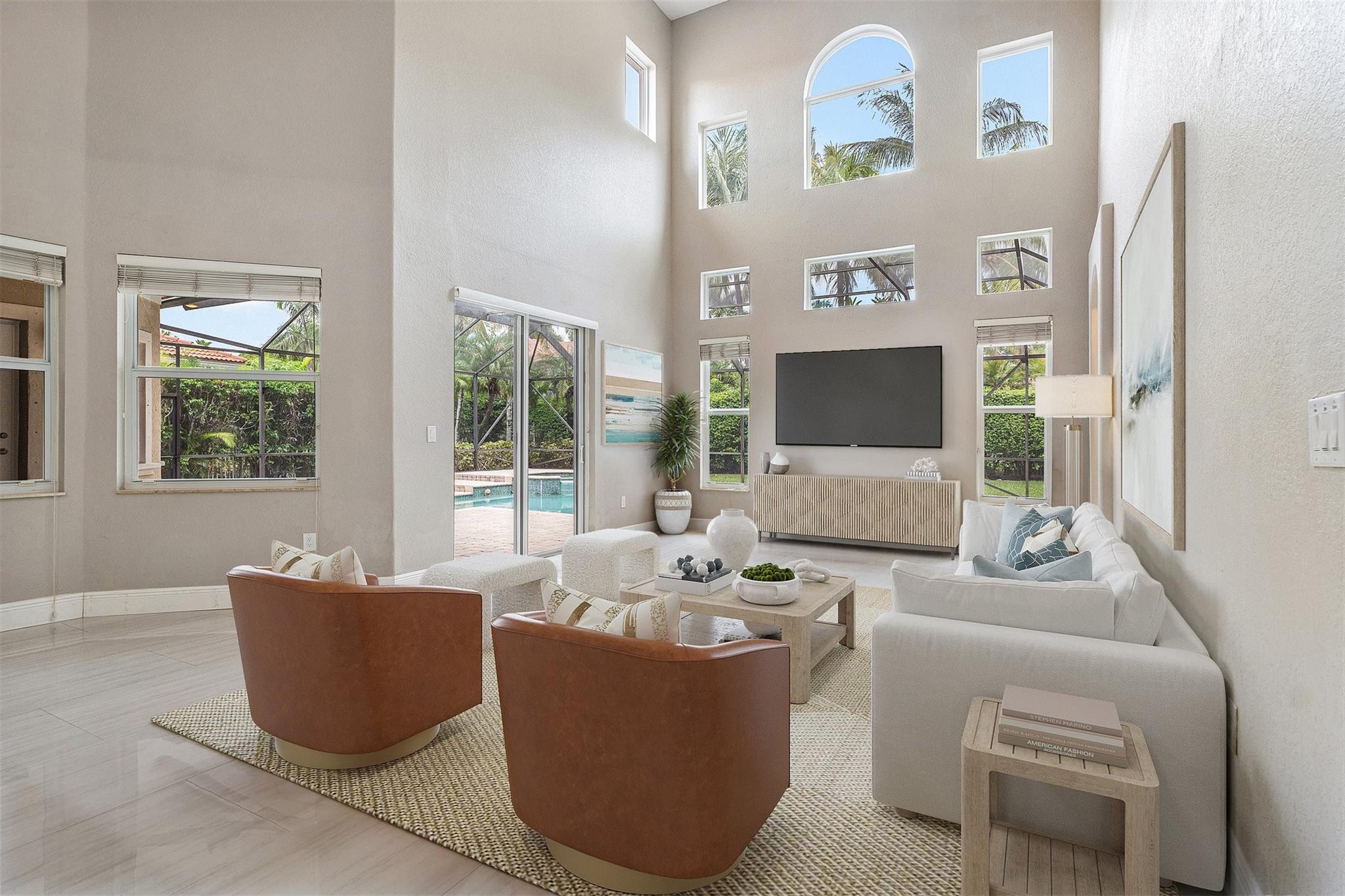 Here are some of the reasons you will love this simply stunning home: Newer Roof, Impact Windows & Doors, New Kitchen boasting an island with waterfall counters, quartz counters, Top of the line appliances, Soaring 2 story ceilings, Expansive Windows/Glass Doors, New flooring, Freshly painted, New A/C, Custom built-in closets & more. First floor bedrooms include the Primary Suite with a spa inspired bath & a guest bedroom with a bathroom. Upstairs there are 3 Bedrooms, 2 Bathrooms & a loft. One bedroom has an ensuite bathroom & 2 have balconies. Step outside to the expansive screened porch where you will find a heated salt water pool with spa & private backyard. Venetian Isles is an exclusive guard gated community & is situated on Coral Springs largest lake. This home will not disappoint!
