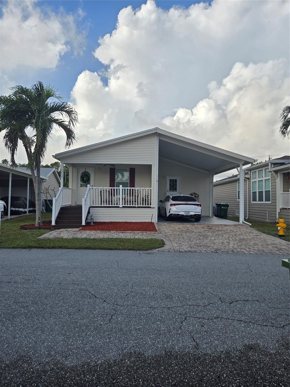 Beautiful, unique open layout, vaulted ceilings throughout, crown molding, knock down drywall, baseboards, laminate floors throughout except bedroom, tile in bathrooms, new total kitchen with pantry, new appliances, new roof and new A/C in 2021, all white kitchen with bar, open concept dining living and kitchen, feels, looks brand new inside. laundry room, 3 bedrooms, large walk in closet in Master, big master bath, huge shower with 2 seats, double sink vanity, guest bath tub/shower, ceiling fans in all rooms, attached carport with side door entry,separate laundry room lots of storage inside, enjoyable covered porch w/fan, underground utilities, gated, 2 huge pools, 2 clubhouses, tennis courts, boat ramp, lighted streets, hot tub, quiet street, great neighbors. come inside and be amazed.