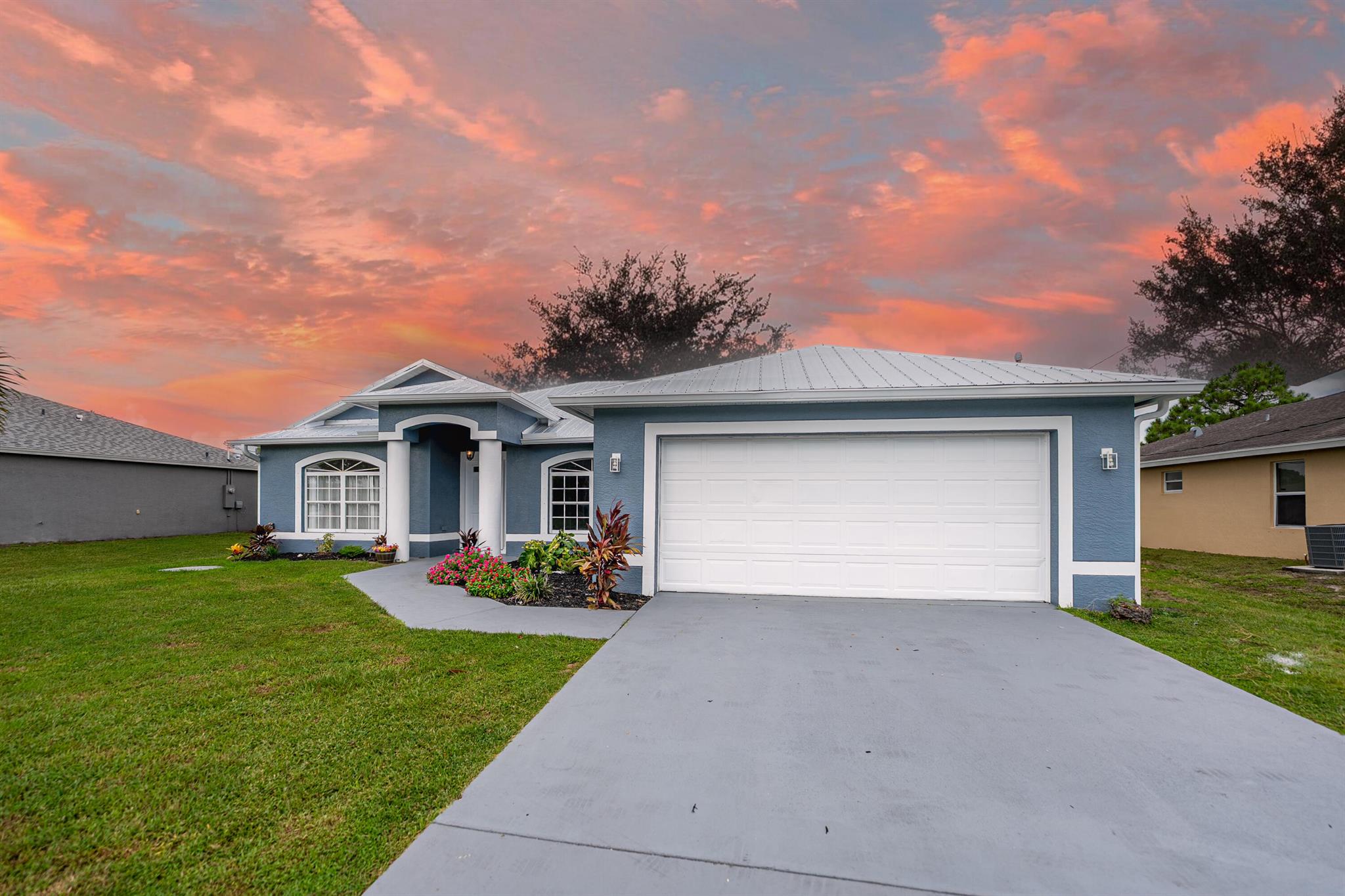 Beautifully updated Groza Builders home with NO HOA! This 3BR/2BA/2CG home features a brand-new metal roof (2025), Corian countertops, stainless steel appliances, and tile flooring in main living areas. Large windows and vaulted ceilings fill the space with natural light. Updates include water heater (2024), full exterior repaint including driveway (2025), interior repaint (2025), and new laminate in one bedroom (2025). Enjoy the screened, under-truss patio and oversized fenced backyard. Prime location near Turnpike, I-95 & shopping!