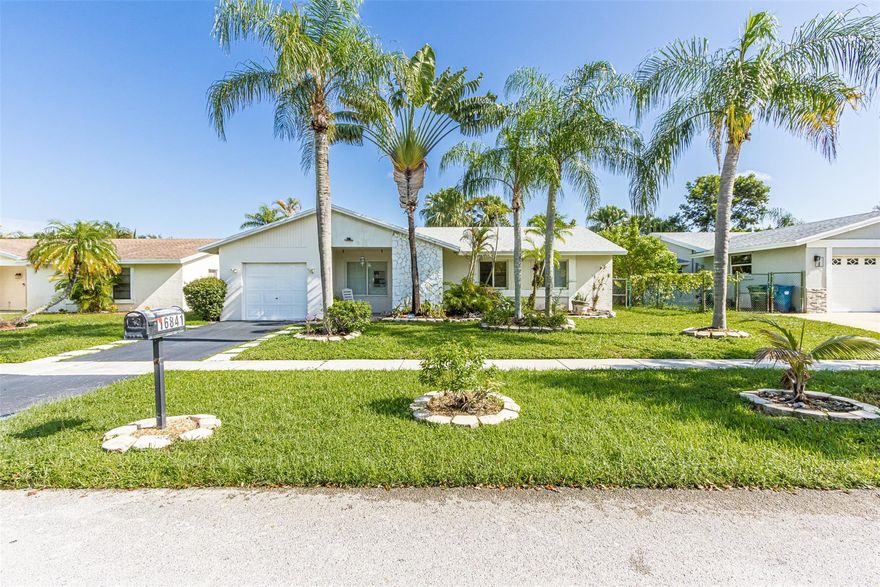This charming home is located in Weston’s best kept secret subdivision in Bonaventure. The unique front entry has glass on 2 sides, allowing natural light to filter in. Step into the inviting living space to find a great room with vaulted ceilings. The kitchen is open to the dining area and has access to the screened and covered patio, allowing for easy outdoor entertaining. The spacious backyard offers a tropical oasis with room for a pool, expansion of the covered patio, and even an outdoor kitchen. Bedrooms and bathrooms are located on the east side of the house offering privacy from the main living area. The home has impact windows & doors, a newer roof (2023), water heater (2022), & A/C (2018). With some fresh paint and your design ideas you can turn this into your showcase home!