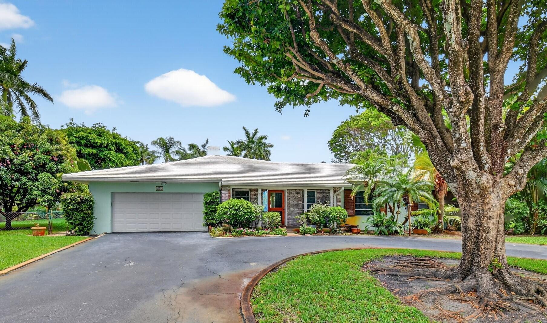 Welcome to this exceptional residence nestled in one of Delray Beach's most sought-after neighborhoods. Situated on a rare 1/2-acre corner lot in the prestigious Lake Ida community, this home offers the ultimate in East Delray living--just two blocks from the lake and mere minutes from the sun-drenched shoreline, vibrant Atlantic Avenue, and a variety of boutique shops, restaurants, and cultural venues. From the moment you step through the front door, natural light fills the interior through expansive panoramic windows that frame serene views of the lushly landscaped backyard and sparkling pool. The Florida room seamlessly integrates indoor and outdoor living, creating an immediate sense of peace and tropical sophistication. This sun-drenched space is ideal for entertaining or simply