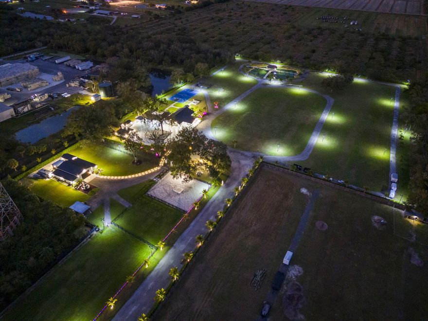 Private 12.45-Acre Luxury Equestrian Estate + Premier Income Opportunity

An extraordinary, fully renovated 12.45-acre private compound offering the perfect fusion of luxury living, equestrian excellence, and premier income-producing event venue potential. Ideally situated within a sought-after equestrian area, this gated estate was completely remodeled in 2022 and thoughtfully designed for upscale lifestyle living, large-scale entertaining, and equestrian operations.

The 5-bedroom, 5.5-bath residence encompasses 3,345 sq ft of refined interiors, featuring large-format tile throughout, a designer quartz kitchen and spa-inspired baths, new metal roof, dual-zone HVAC systems, updated electrical and plumbing, new septic system, and full impact windows and doors for enhanced security and efficiency.

Outdoors, the estate unfolds into a true resort-style retreat and event-ready showcase. Amenities include a fully equipped outdoor kitchen, elegant pergolas, custom outdoor fireplace, NBA basketball court, solar landscape lighting, irrigation system, and a picturesque ½-acre stocked pond complete with dock, bridge, and tiki hut creating a breathtaking backdrop for luxury events, weddings, private celebrations, and corporate retreats. For guest convenience during events, the property also features dedicated exterior restroom facilities, including an exclusive men's half bath and a separate women's full bath.

Equestrian improvements are equally impressive, highlighted by a 2,560 sq ft barn with 8 stalls, washroom, saddle room, and adjoining fenced pasture areas suitable for turnout and grazing, with over $400K invested into equine infrastructure. Within the equestrian section of the property, a renovated on-site camper provides private accommodations ideal for a groundskeeper, trainer, or equestrian staff member.

A comprehensive, professionally installed surveillance system is strategically positioned throughout the property, providing enhanced monitoring and peace of mind across the residence, barn, and grounds.

A grand gated entrance with waterfalls and smart call box completes this exceptional estate, delivering unmatched privacy, scale, and versatility perfect as a luxury private residence, equestrian compound, or high-end income-producing event venue in the heart of St. Lucie County.