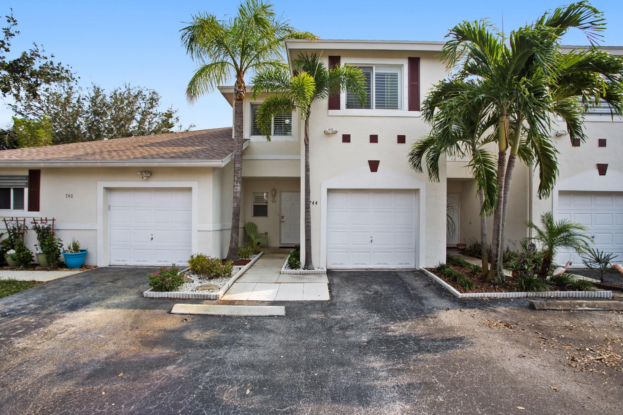 Gorgeous 3-bedroom, 2.5-bath townhouse with 1-car garage and 2 additional parking spaces. Enjoy new vinyl floors downstairs, fresh paint, an updated 1/2 bathroom and kitchen with granite counter top, stainless steel appliances and pantry that opened to the living room area. Upstairs features wood floors, a spacious primary suite with updated master bath and walk-in closet. The other 2 bedrooms with an updated bathroom and the laundry room. Head outside to a private fenced courtyard, perfect for relaxing or pets. Community offers a sparkling pool. Just 5 minutes to I-95, Turnpike, Publix, Costco, hospital, restaurants, and more. Pet-friendly with no breed or size restrictions! Accordions shutters on the second floor.
