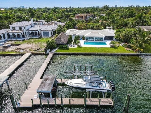 Direct Intracoastal Dream. Private dock: 3 slips w/ lifts. 150 ft of water frontage. Available now furnished; turnkey. Located on a sprawling 36,000+ sq ft lot, this North Flagler Drive home is a boater's paradise. This one of a kind 5-bed, 5-bath home features a brand new kitchen, massive primary walk in closet, sauna, movie room, large 50 ft pool overlooking intracoastal, hot tub, fire pit, summer kitchen, outdoor shower & 2 car garage. Be the best host in town with your own oversized backyard Tiki Hut, equipped w/ commercial grade wrap around bar, 3 television's. Enjoy surround sound throughout the interior/exterior with your user friendly Sonos speakers. With stunning views of Palm Beach from every angle, this 5,000+ square foot house offers light-filled rooms & luxury living.