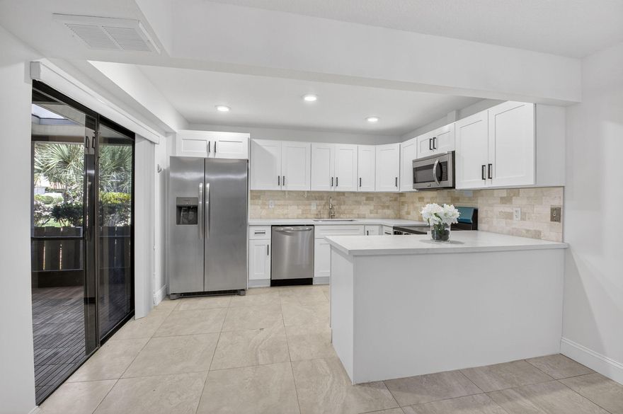 Welcome to your private coastal retreat in the heart of Delray Beach—where modern luxury meets serene, spa-inspired living. This renovated 2-bedroom, 2.5-bath residence offers a rare blend of sophistication and tranquility. From the moment you step inside, you're greeted by a calming, zen-like aesthetic—freshly painted interiors, a striking beach-inspired stairwell accent wall, and thoughtfully curated finishes that evoke a high-end resort experience. The fully equipped kitchen, featuring sleek white quartz countertops paired with brand-new stainless steel appliances, including a refrigerator and range/oven—perfect for both everyday living and entertaining in style. Each of the 2.5 bathrooms has been completely renovated, delivering a spa-like ambiance with modern finishes and a clean, elevated design. Step outside onto your brand-new natural wood patio—an inviting extension of your living space, ideal for morning coffee, sunset unwinding, or hosting under the South Florida sky. Additional upgrades include a brand-new HVAC system, ensuring comfort and efficiency year-round. Location is everything—and this home delivers. You're just a short drive (approximately 10-12 minutes, about 3 miles) from Delray's pristine, award-winning beaches, where turquoise waters and vibrant beach culture await. Enjoy easy access to the upscale boutiques, art galleries, and renowned dining scene along Atlantic Avenue—featuring everything from chic cafés to world-class restaurants and lively nightlife. Whether you're seeking a full-time residence or seasonal escape, this 55+ community offers 5 pools, clubhouse, fitness center, tennis courts, and a scenic, walkable environment with calming lakes and lush landscaping. This home offers the ultimate in luxury coastal living—where every detail has been elevated, and every day feels like a getaway.