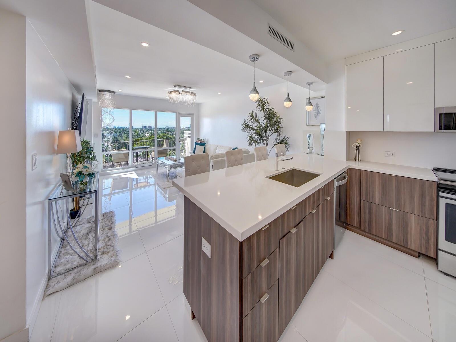 Wow, this beautiful unit is located on the famed Las Olas Blvd!  From the moment you enter you are greeted with lots of natural sunlight  and breathtaking views of the intracoastal, and ocean.  This spacious floor-plan is fully remodeled.  Spectacular modern kitchen boasting quartz countertops, real wood cabinets, S.S. appliances and upgraded Porcelain white tile throughout.  The master bedroom is complete with a huge walk-in closet.  The master bath boasts his and her sinks, seldom found in a condominium. Top-of-the-line, GE profile washer and heat pump dryer all in one!   Las Olas is the ideal location with shopping, restaurants, galleries, wine bars and more just a short walk over the bridge.