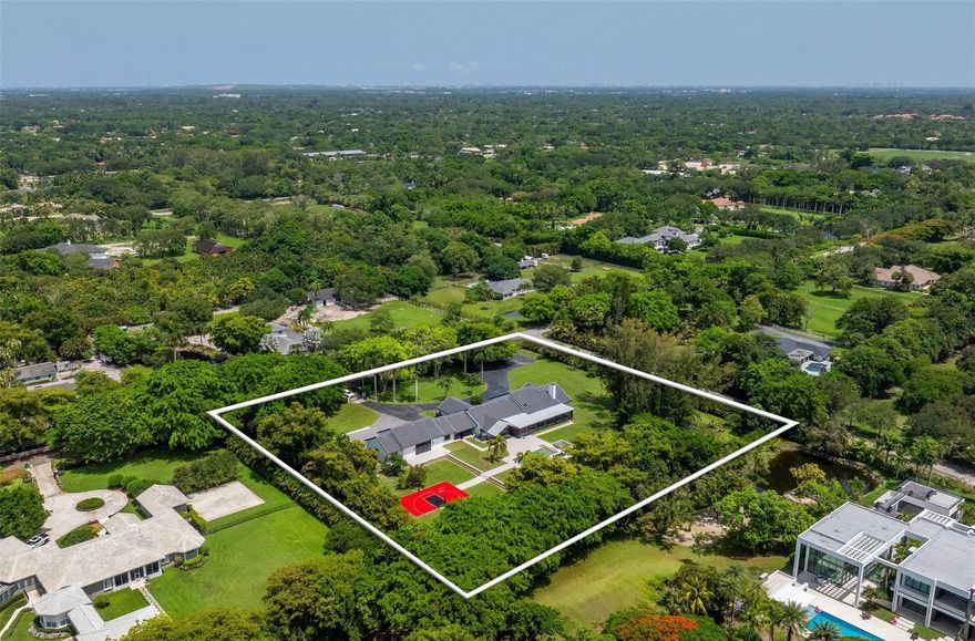 Welcome to an elegant sanctuary where design, privacy, and lifestyle unite in perfect harmony. Set on nearly 3 acres, this fully renovated estate—styled with Restoration Hardware finishes—features 5 bedrooms, 4.5 baths, and a flowing open-concept layout. Extensive upgrades include new roofing, full rewire with LED and Cat5/6, whole-home audio, a custom home theater, smart gate system, new kitchen and baths, decorative ceilings, and 4,000 SF of pavers. Outdoors, enjoy a resort-style pool, basketball court, two outdoor bars with pergolas, lush landscaping, and a 2,100-SF garage. Additional highlights include smart home integration, custom closet systems, enhanced insulation for year-round efficiency, and a serene screened porch. Sophisticated, smart, and truly turnkey.