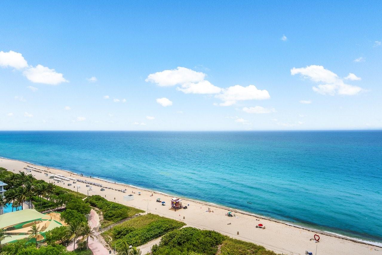 Experience breathtaking full ocean, state park, and Intracoastal views from this renovated corner unit at Mar del Plata. This meticulously updated condo features a new full bath, renovated kitchen, new light fixtures, recessed lighting, and a new washer/dryer. Enjoy abundant custom closet space, impact windows with treatments, and updated AC. The enclosed den offers a versatile space with a double Murphy bed. The building boasts amenities like a pool deck, gym, sauna, and direct beach access. Close to South Beach, Bal Harbour, and a dog park. Live the Miami Beach dream today! Seller will take care of all assessments upon sale.