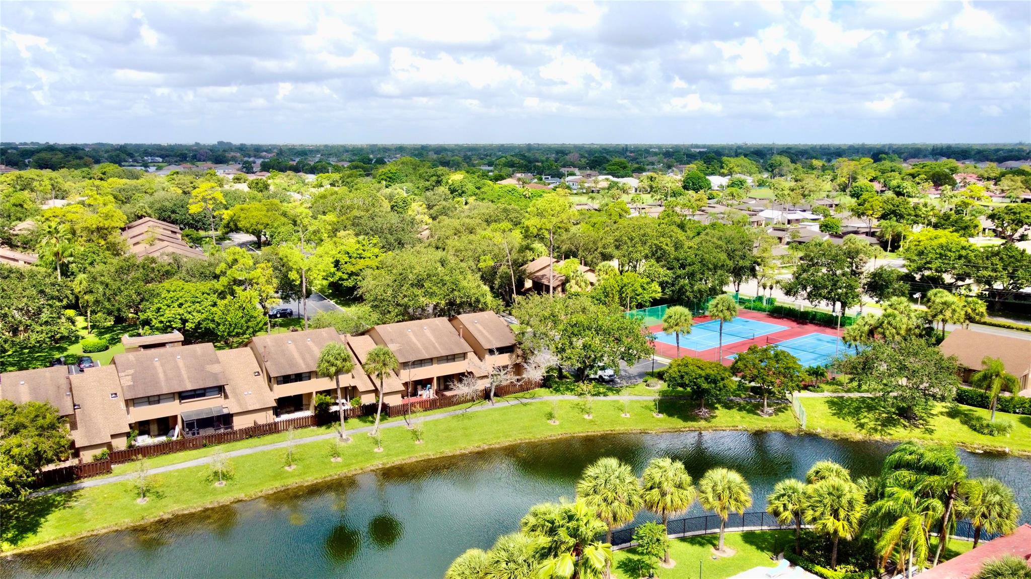 This stunning 3 beds and 3 baths townhouse in the desirable Bonaire at Woodmont boasts breathtaking water views. Inside, enjoy a bright, open kitchen and family room, perfect for entertaining. The upper level features a split bedroom layout, with a luxurious primary suite and a secondary room, each with its own full bathroom for added privacy. Step outside to your spacious fenced back patio and charming front porch, ideal for morning coffee or evening relaxation. Embrace an active lifestyle with nature walks, golf courses, and a variety of shopping and dining options just minutes away. With 2 designated parking spaces and ample guest parking, convenience is key. This gated community offers fantastic amenities like a gym, pool, and tennis facilities all within walking distance. Easy to show