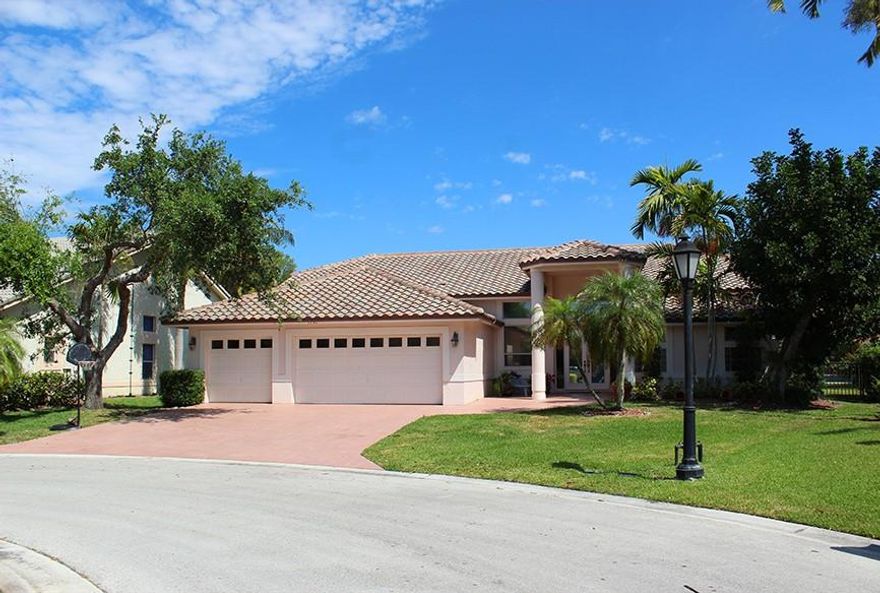 wOw! Your next home awaits you in the Fairways at Eagle Trace! Located on a quiet cul-de-sac, don't miss this beautiful 5 bedroom, 3 bath single family home with a huge 3 car garage. Very open and spacious home with high ceilings, large kitchen with island that leads out to the large screened in patio and looks over the pool. Beautiful master suite and very modern master bath.  Tile and laminate floors throughout the home. Incredible back yard combined with the enclosed patio and pool beyond, the perfect place to enjoy your South Florida lifestyle!