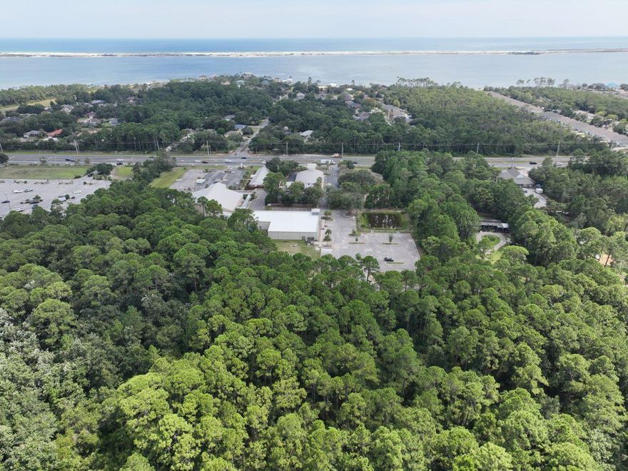 This pristine, non-HOA 1.13-acre lot in Navarre is zoned R-1M and buildable.  The location of this wooded parcel falls within the designation ''wetlands'' zone. Engineering report attached quotes the approx. wetland mitigation & permitting fees between $3K - $4K. This parcel is accessible through Timber Ln. which is maintained by Santa Rosa County.  Zoned a mixed residential subdivision, the addition of Single Family, Manufactured, Modular and Mobile homes is permitted.  Short term vacation rentals are also allowed with no regulations by the county.  Other permitted land uses include community gardens and group homes with 0-6 residents. Holley-Navarre Water & Sewer provides services to this address. This is 1 of 3 exactly alike, side-by-side lots available for sale. No limit on purchase.