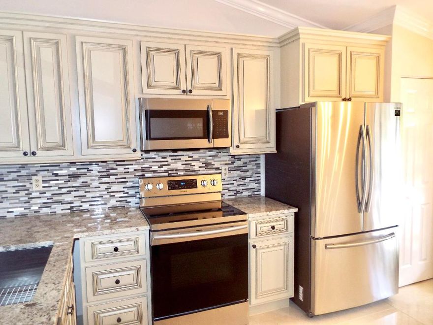 You Can Own a Piece Of Heaven in This Tree Lined Quite Peaceful & Friendly Community. Very Rarely Seen 2 Bedroom & 2 Bathroom Unit Equipped With Hurricane Shutters Throughout. This Totally Renovated Top Floor Unit With Eat In Kitchen Features 42 Inch Custom Wood Cabinetry,  Crown Moulding ,Granite Counter Tops,SS Appliances & SS Sink With Disposal. Both Bathrooms Are BeautifullyTiled From Floor to Ceiling With Italian Porcelain, Beautiful Custom Wood Vanities Toped With Granite & The Walk In Shower is Done with The Same Italian Tile Accompanied By Frameless Shower Doors. The Entire Unit Flooring Is DoneWith Italian High Gloss Porcelain.  This Unit Offers a Large Master Bedroom with Walk In Closet & Sliding Glass Doors Out To The Patio. Nice Size 2nd Bedroom With Sliders & Full Size Closet You Will Enjoy This Park Like Community For It's Beautiful Landscape & Open Spaces. Our Amenities Are Plentiful Such As a Heated Resort Style Pool With Chairs , Billiards, Tables & Umbrellas, Screened In Patio Off Of The Pool Area For Shady Relaxation, Barbecues, Fitness Ctr & Library.  The Community Is Chock Full of Things To Do For Its Residents Such as an Assortment of Classes , Trips & Gatherings.