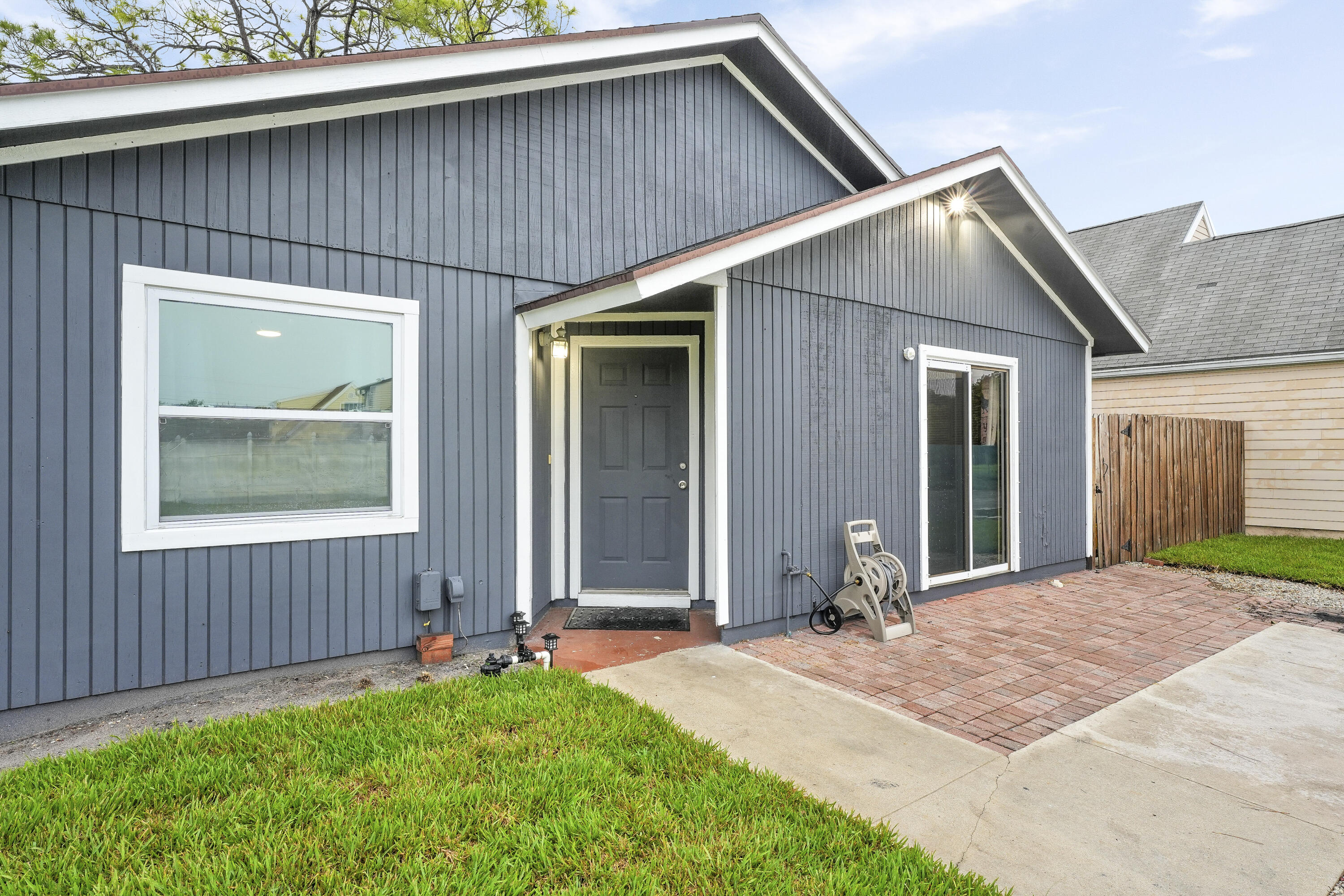 Welcome to this beautifully maintained 2-bedroom, 2-bathroom single-family home situated on a spacious corner lot in a desirable neighborhood. From the moment you arrive, you'll love the inviting curb appeal, fresh exterior paint, and private driveway. Step inside to find a light and bright open-concept layout with modern touches throughout. The main living area features stunning slate flooring, updated lighting, and a cozy flow into the dining area--perfect for entertaining. The kitchen offers ample cabinet space, stainless steel appliances, and a pass-through window for convenient hosting. The spacious primary suite includes a walk-in closet and an ensuite bath, while the guest bedroom is equally inviting.