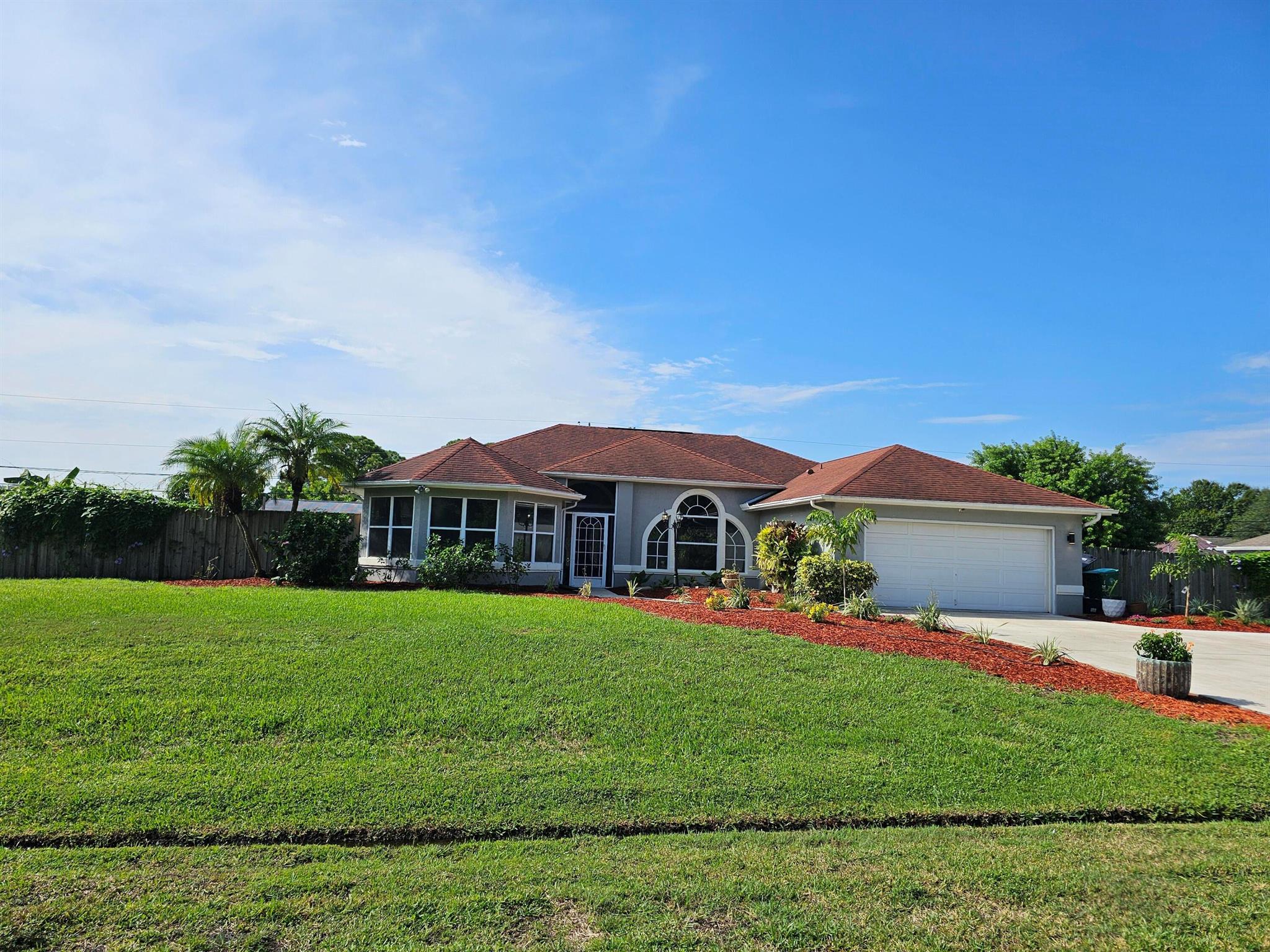 Newly renovated family home. This gorgeous home is a 3/2 with a pool on a double lot. Prime location in Port Saint Lucie! Five minutes from I-95 and ten minutes from either Tradition or Saint Lucie West. New floors, bathrooms, and stainless-steel appliances! Move in ready! -Roof under 10 years -AC 3 years old -Hot water heater 2 years old -Saltwater pool -Lot 0.46 acre -Multiple fruit on trees on property