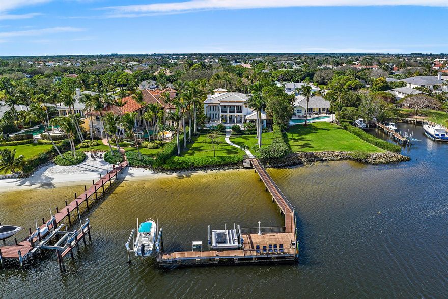 BRING ALL OFFERS! Welcome to a boater's dream home. A rare opportunity to own a premier waterfront estate in Palm Beach Gardens, designed for those who love life on the water. This Intracoastal masterpiece boasts 100 feet of direct waterfront, a 120-foot deep-water dock, and no fixed bridges, providing effortless access to both the Jupiter and Palm Beach Inlets. Set on nearly an acre at the end of a quiet cul-de-sac, this custom-built estate was remodeled in 2018 and offers the perfect blend of luxury, privacy, and functionality. With five bedrooms, eight and a half bathrooms, and 10,803 total square feet, this home is an entertainer's dream, designed for seamless indoor-outdoor living. One of the largest lots in Commodore's Pocket.