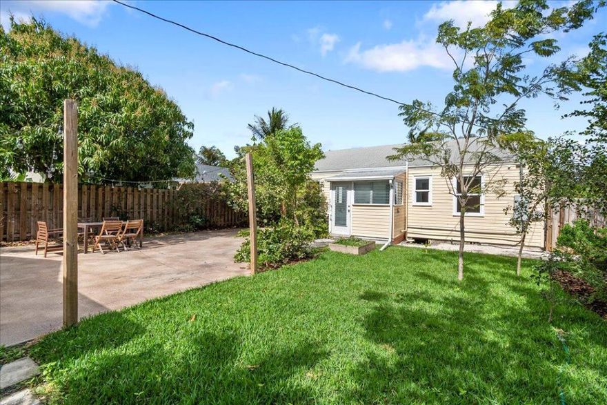 Beautifully renovated home and detached oversized garage with AC that could be converted into charming cottage for guests or rental income.  Main home has 2 bedroom, 1 bath single family home completely remodeled. Restored oak wood flooring in living room and bedrooms. Carrera tile floors in kitchen and bathroom. Impeccable kitchen with stainless steel appliances, granite countertops, shaker cabinets with self-closing drawers. New impact windows, upgraded electric, new A/C system throughout, high hat lighting, tankless water heater. Great curb appeal includes a long driveway and large fenced backyard, newly landscaped.