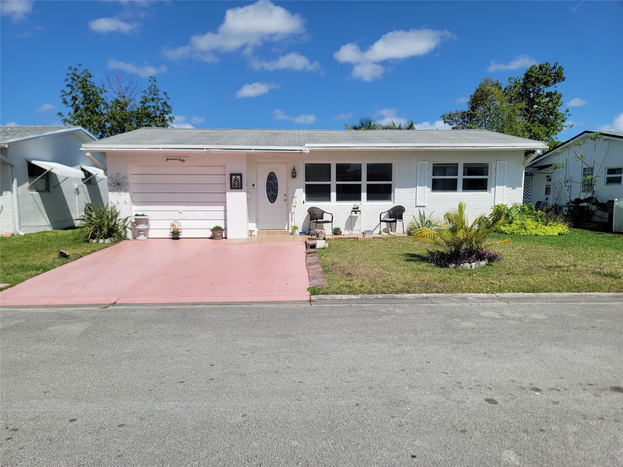 Beautiful two bedroom, one bathroom home located in Paradise Garden 55+ community. Great layout features an oversize florida room with a beautiful view of the back yard. The garage is currently being used as a 3rd bedroom but can easily be converted back into a garage. Nice size laundry/utility room. Home comes with a water purification system and tankless water heater. Double wide driveway that can easily fit two cars. Low HOA that covers lawn care, community pool , Club house and exterior painting of home approximately every 5 years.