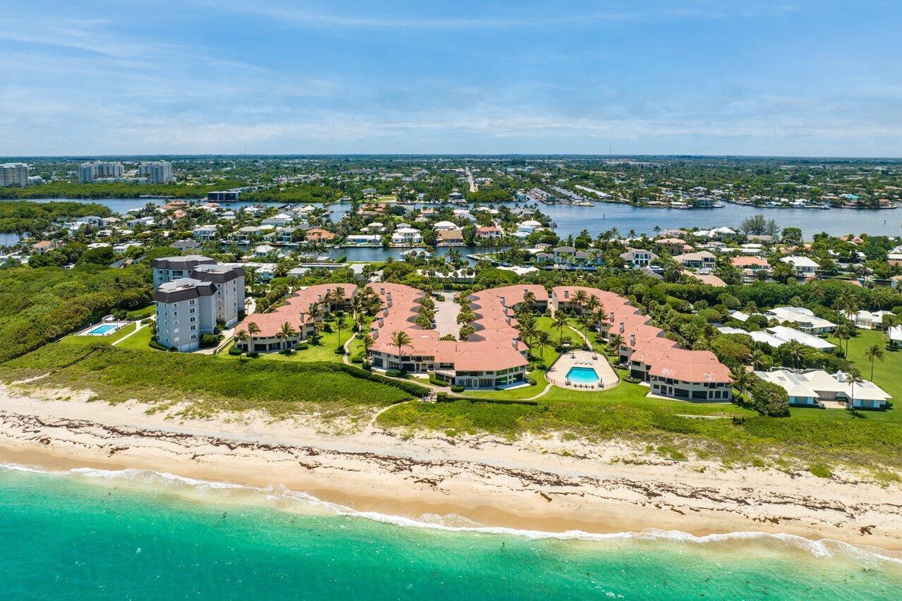 Oceanfront property with private beach access! Enjoy Carefree Living in Upscale Ocean Ridge. Located in the gated community of The Dunes in beautiful Ocean Ridge, this 3000-sf townhouse with 3/BR- 3.5/BA is the perfect home to enjoy the wonderful south Florida lifestyle. From the moment you drive through the security gate onto the brick-paved courtyard drive, you'll know that careful attention has been given to every detail in this gorgeous complex. Enter the new impact front door with frosted glass and be impressed with the spaciousness of the modern, open floor plan with Wainscotting and porcelain tile flooring throughout most of the first floor, all bathed in natural light, and accented by the fantastic views of the ocean from virtually everywhere on the main floor through high