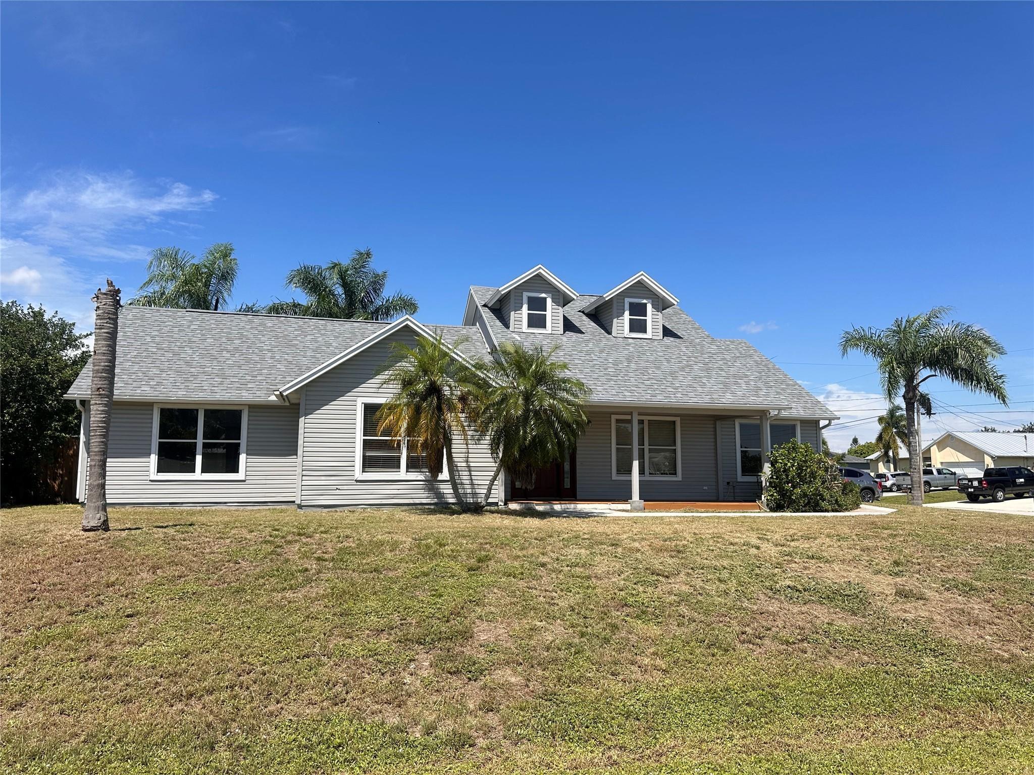 Welcome to this beautifully updated 3-bedroom, 2-bathroom home located on a desirable corner lot in a quiet Port St. Lucie neighborhood. The open floor plan features a bright living area, modern kitchen with stainless steel appliances, and spacious bedrooms with plenty of closet space. The primary suite includes a private bath and walk-in closet. Enjoy a large fenced yard, perfect for outdoor living and entertaining. Additional highlights include tile/laminate flooring throughout, fresh paint. Conveniently located near A-rated schools, shopping, dining, I-95, and the Turnpike.