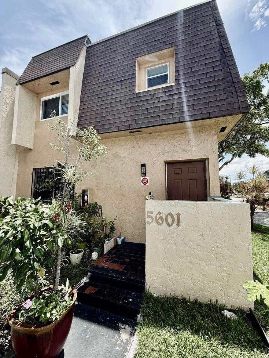 Spacious 3-bedroom, 2.5-bath two-story condo offering 1,428 sq ft of interior living space. The first level features a bright living and dining area, tile flooring, and a kitchen with updated countertops, cabinetry, and an extended serving bar. A half bath and laundry room are also located downstairs. Upstairs includes three bedrooms with wood-style flooring and two full bathrooms, including a tub/shower combo. The primary suite offers generous space and closet storage. Enjoy a screened-in patio and fully fenced garden area with outdoor access. Assigned parking included. Centrally located near schools, major roads, and shopping centers.