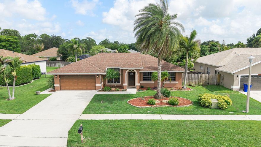 Welcome to this beautifully maintained 3-bed, 2-bath home in the heart of Royal Palm Beach! Soaring vaulted ceilings and an open-concept layout flood the living and dining areas with natural light, perfect for entertaining or relaxing. The kitchen features rich wood cabinetry, tile backsplash, and a breakfast bar that flows into the main living space. The generous primary suite is a true retreat, with two additional bedrooms perfect for guests or a home office. Sliding glass doors bring the Florida sunshine in. Recessed lighting, neutral finishes, and abundant storage maximize every inch.