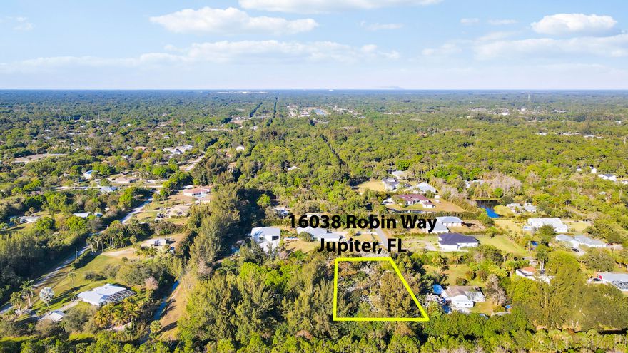 Jupiter Farms 1.19 acres on paved road. Lush tropical vegetation with excellent elevation. Canal access to River Bend Park and Jonathan Dickinson. Rare Lot for sale in Jupiter Farms. This is one of but a few remaining buildable lots currently for sale on Loxahatchee River in Jupiter Farms Florida. Located at 16038 Robin Way, the 1.19 acre property has 170 feet of frontage on a waterway feeding directly into the northwest fork of the Loxahatchee River. The river, described as ''one of the last two wild and scenic rivers remaining in Florida'', passes through Jonathan Dickinson State Park before emptying into the Jupiter Inlet and eventually the Atlantic Ocean. Since being purchased in  2000, the lot has seen twenty six years of continuous planting of tropical plants resulting in creating a subtropical rainforest with giant Kapok Monkey Pod, African Tulip, and a variety of huge Banyan trees to name but a few. A variety of palms, both native and nonnative together with giant bamboo are scattered throughout the property.The waterway bordering the back of the lot is home to alligator, manatee, otter, etc. As part of the greater Loxahatchee River Watershed, the waterway is popular for canoeing and kayaking. Riverbend and Loxahatchee River Battlefield Park borders the other side of the canal and offers hiking, biking, and horseback riding trails and the assurance that no homes or development will occur  on that side of the waterway. On secluded end of street abutting another vacant lot with million dollar properties nearby, the lot offers privacy and solitude in a tropical garden setting.