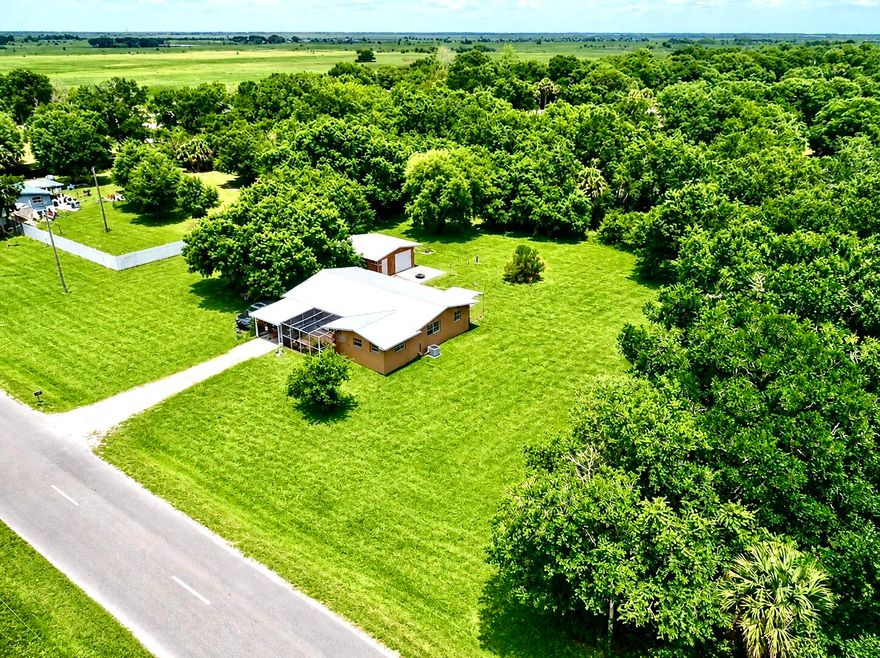 Welcome to Dixie Ranch Acres—NO HOA! This charming 3-bedroom, 1-bath CBS home sits on a spacious 1-acre lot, offering plenty of room to relax and enjoy the outdoors. A 2018 metal roof provides peace of mind for years to come. Step outside to a bright and inviting screened-in patio with a water feature, overlooking the expansive yard—perfect for morning coffee, entertaining, or evening unwinding. This versatile space also features a tranquil garden-style corner with decorative stone accents and lush greenery. A 20x20 garage offers ample storage or workspace, while mature oak trees provide beautiful shade and a peaceful retreat. Additional highlights include a tankless water heater and a security system with cameras. Enjoy the tranquility of country living with the convenience of being just minutes from town. A wonderful place to call home—schedule your private showing today!