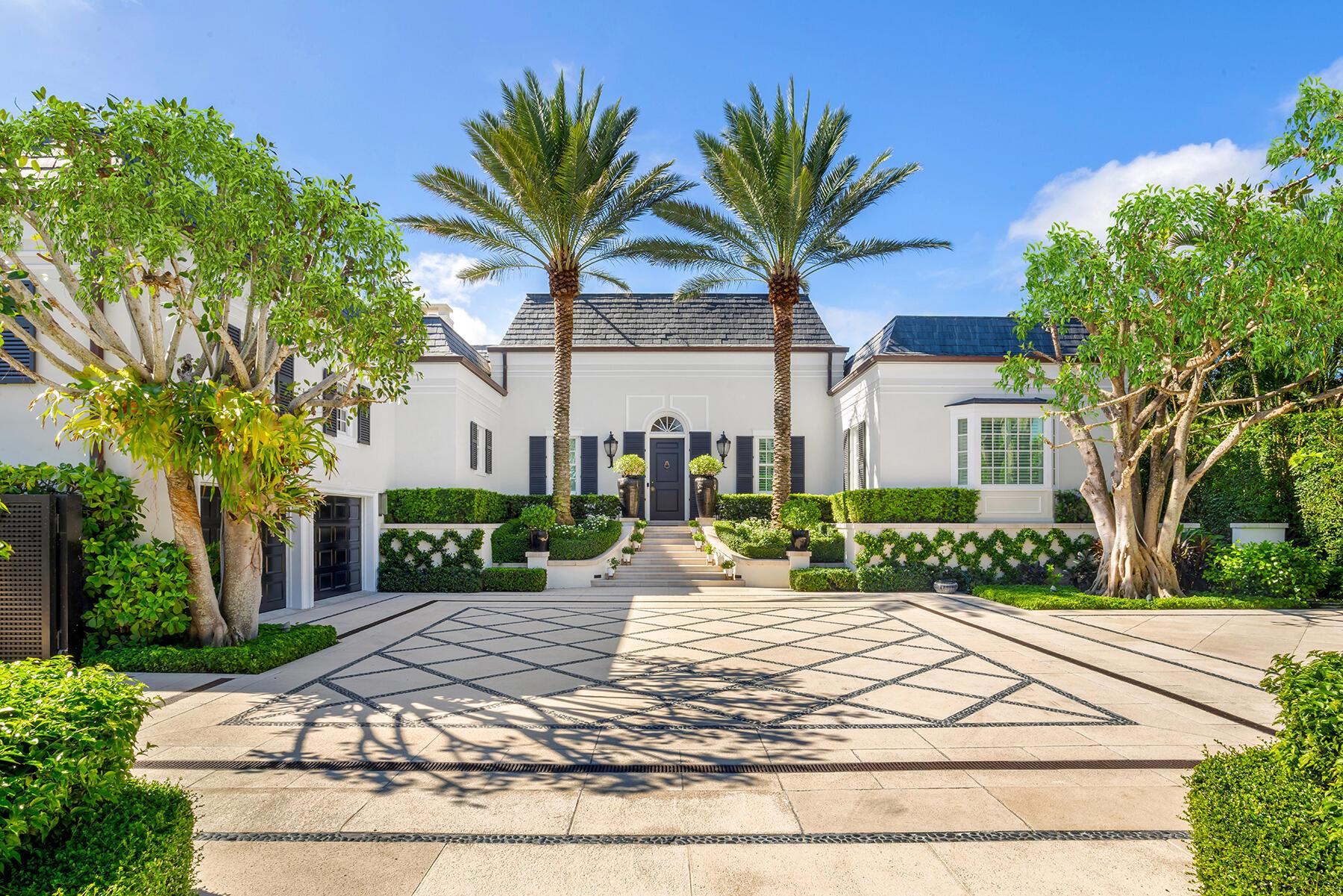 Tucked away on one of Palm Beach's most coveted cul-de-sacs and just a short stroll from the vibrancy of town, 134 Casa Bendita is a turn-key and timeless architectural jewel that seamlessly blends classic elegance with modern sophistication.From the moment you arrive, this stunning home captivates with its impressive street appeal, a grand facade, and meticulously curated designer landscaping that sets the tone for what lies within. Step inside to soaring 18-foot ceilings and a voluminous, sun-drenched great room, a true showstopper - and the heart of the home - which is both dramatic and inviting. Providing unparalleled indoor-to-outdoor living on an oversized lot, the residence is perfectly suited for both refined entertaining and quiet repose.