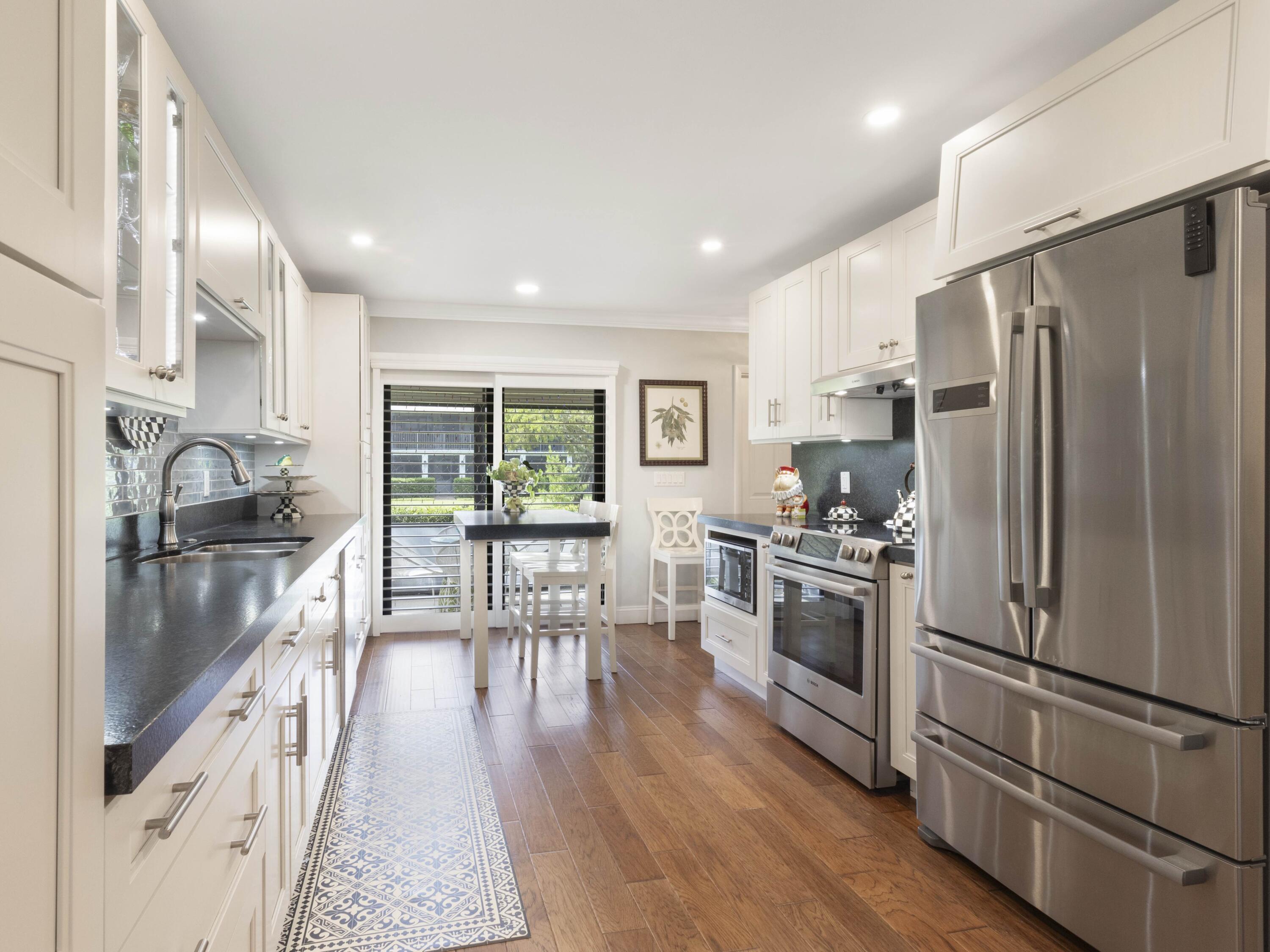 This beautifully renovated design inspired 2 bed/2 bath condo just east of US-1 in Eastview Village Sq. is nestled within the sought-after neighborhood of Tropic Isle surrounded by multi-million-dollar homes. This residence features a new roof, impact windows, an updated electrical panel, new AC and tankless water heater, washer/dryer in a separate laundry room and hardwood floors throughout. The modern kitchen is equipped with new Bosch appliances and custom lighting, spacious bedrooms with custom closets, and stylishly updated bathrooms. Enjoy coastal living in the large 1st floor lanai or by the updated community pool with the added convenience of being just minutes to the beach and vibrant downtown Atlantic Ave! This quiet gem of a home offers flexible leasing and generous parking.