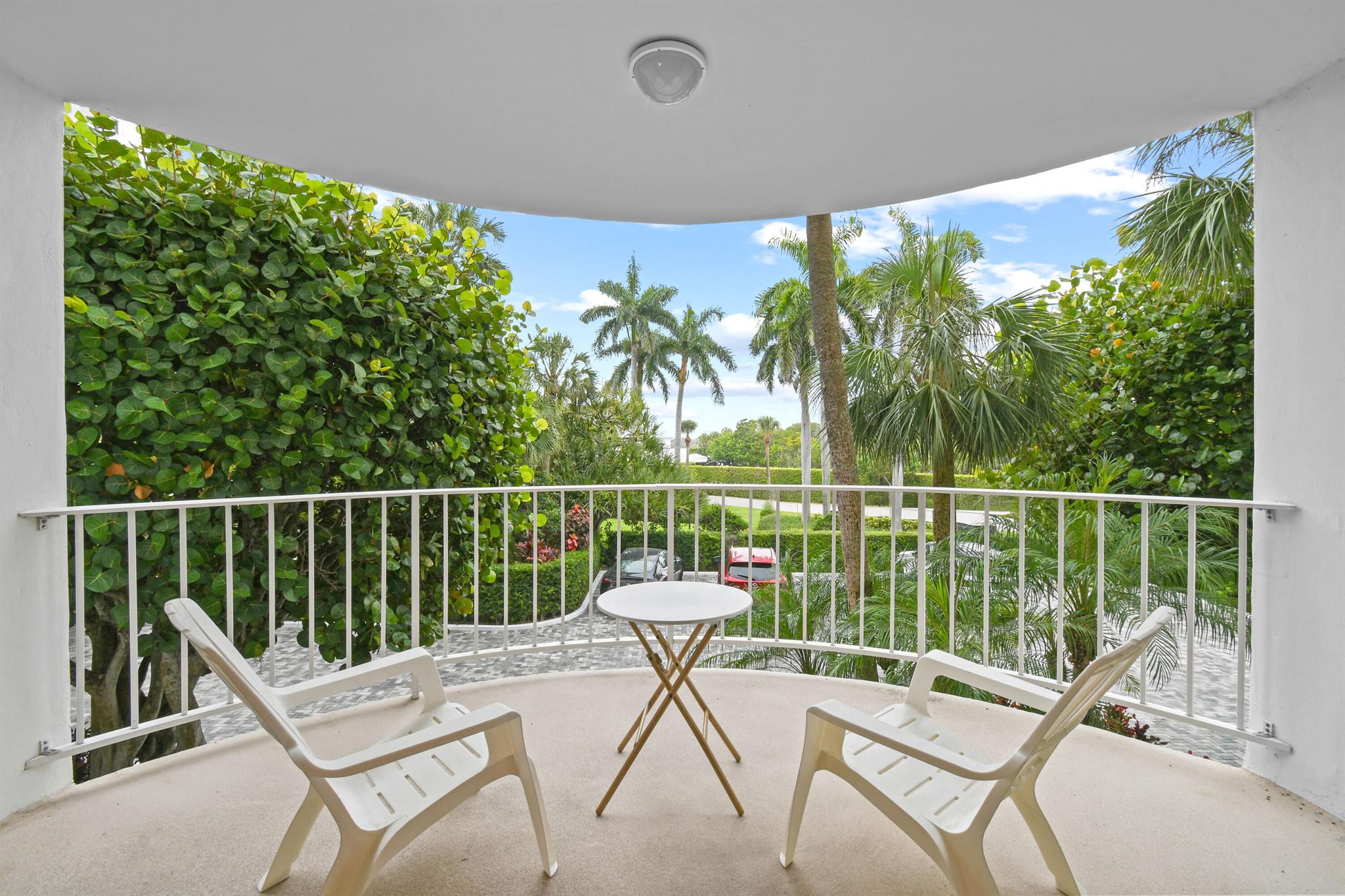 Beautifully Renovated Two-Bedroom Garden Apartment, steps from the Ocean. This nicely renovated two-bedroom, two-bath garden apartment offers a desirable west-facing view with a stacked floor plan just steps from the pool area. The expansive, light-filled living space is bright and inviting, enhanced by high-impact sliding glass doors that open to a lushly landscaped terrace. With 1,669 square feet of interior and exterior living, this residence provides the perfect setting to enjoy the gentle Florida breezes. The unit has been fully updated with stone flooring, a stylish open kitchen, bar, and dining area. Custom cabinetry adds a touch of refined contemporary comfort while maintaining a relaxed, coastal feel. Additional features include a covered parking space and a private storage.