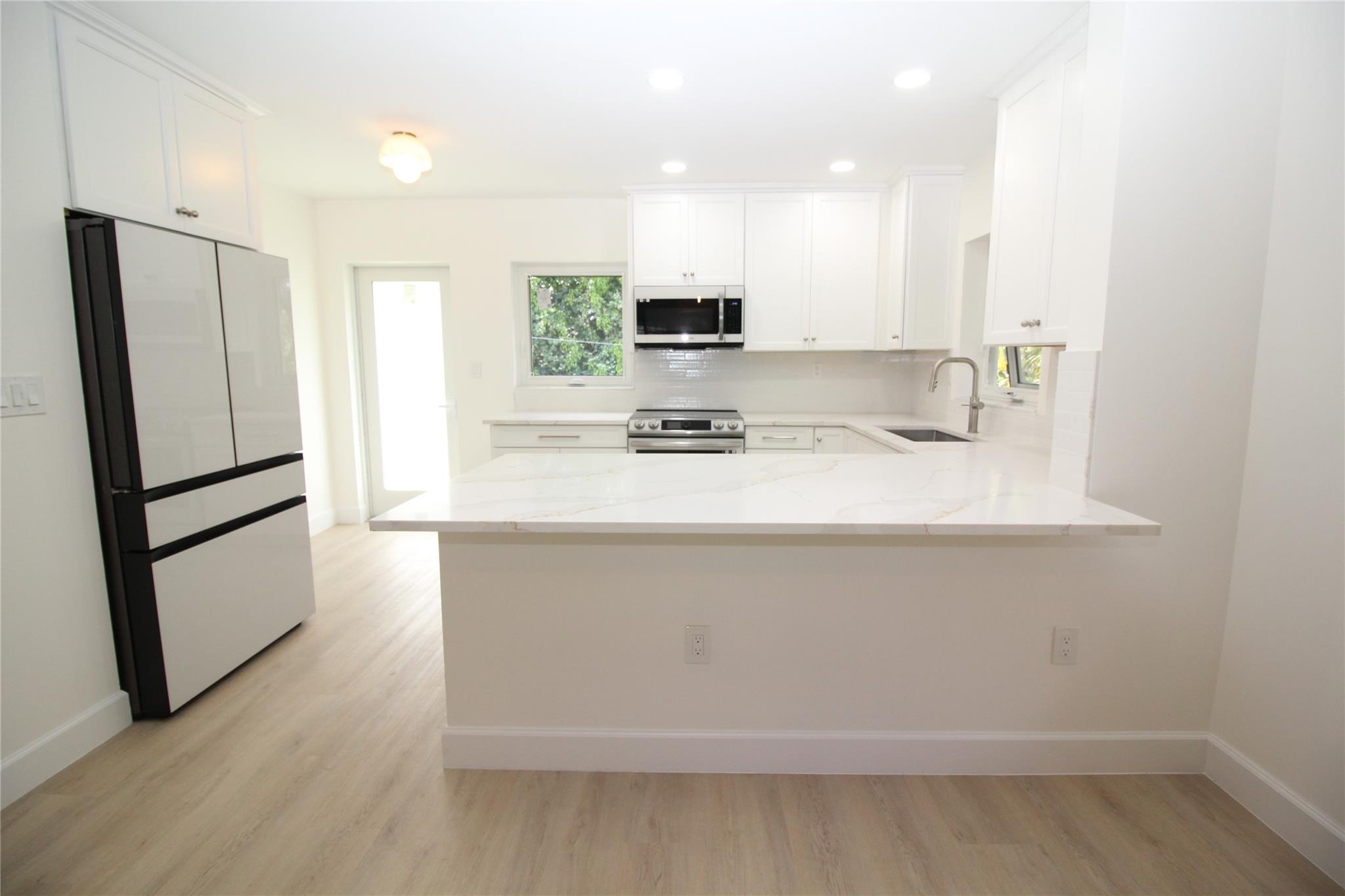 Completely renovated 2-bedroom, 2-bathroom apartment in sought-after East Boca Raton. Positioned on the second floor, it offers convenient access from both the front and rear of the building. The closets feature built-in organizers, providing ample storage. With hurricane-impact windows throughout, safety is ensured. Enjoy a spacious enclosed patio area perfect for unwinding. Covered assigned parking and extra guest parking available. The washer and dryer are conveniently located within the unit. The complex is within walking distance of markets, restaurants, and entertainment venues. The front patio area undergoing re-screening. No pets or smoking allowed.