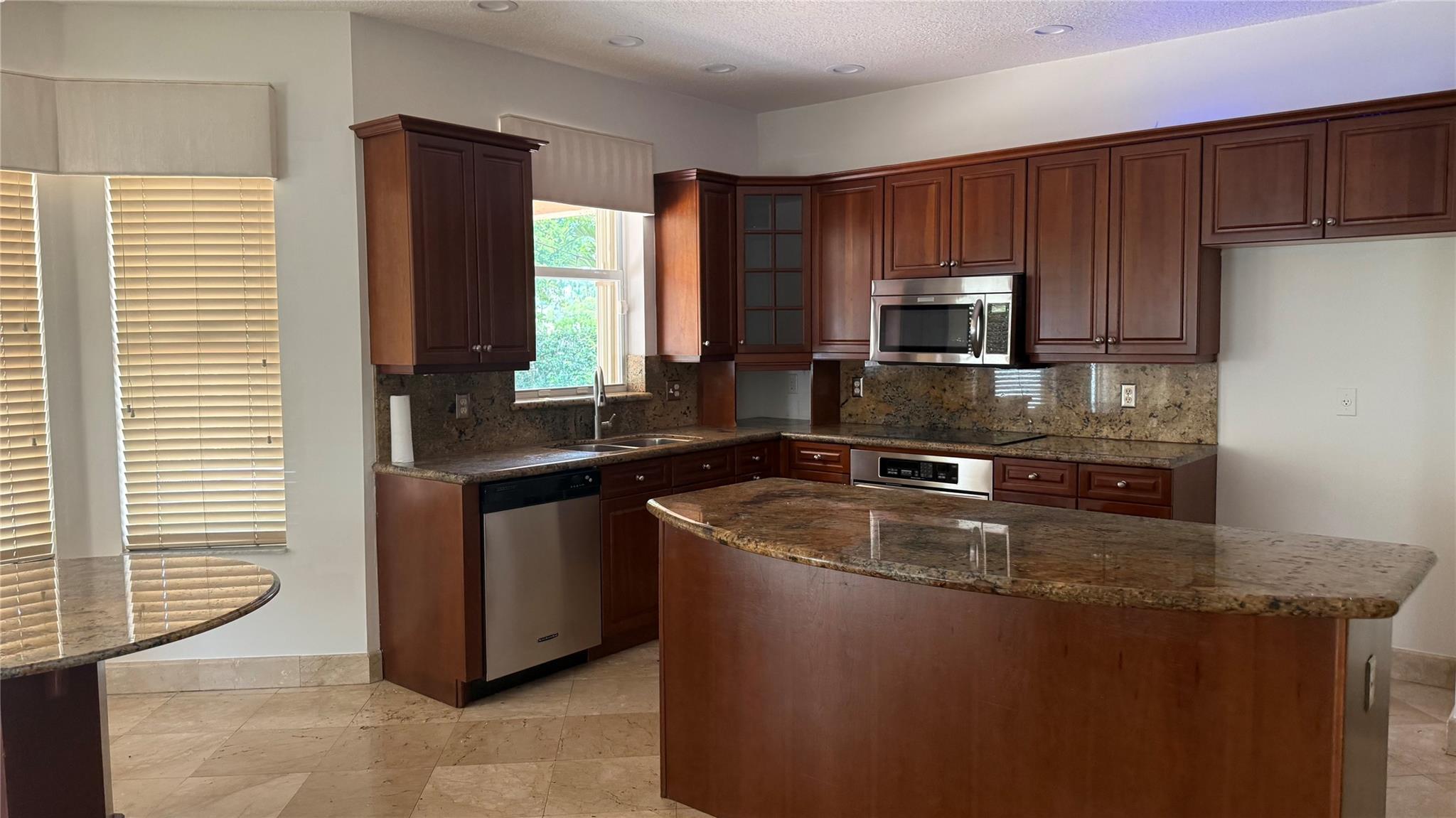 ? Only 1st month + 1 security deposit to move in ($500 cleaning fee)! This spacious 5BR/3BA home in gated Pembroke Shores offers the perfect blend of comfort and style. Soaring ceilings and abundant natural light create an airy feel throughout. The open kitchen shines with granite counters, wood cabinetry, and stainless-steel appliances. Relax in a generous primary suite with walk-in closet and spa-inspired bath. Entertain with ease in the private fenced backyard featuring a covered patio. Enjoy 24-hr guard-gated security, top schools, and unbeatable access to I-75, shops, and dining
