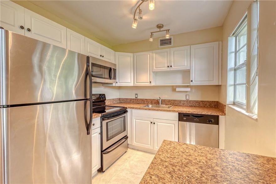 Lovely and Bright 1st Floor, Corner Unit. This updated 2 bedroom 1 and one half bathrooms features beautiful laminate flooring, and newer tile flooring, large walk-in closet, and roll down storm shutters on the porch. Uniquely situated with beautiful trees with no condo buildings behind the unit, providing a peaceful setting. Enjoy the numerous amenities that Century Village has to offer, including their massive Clubhouse, Theater, Fitness Facility, Courtesy Bus, Heated Pools and much more. Conveniently located near I-95, Florida Turnpike and the Sawgrass Expressway.