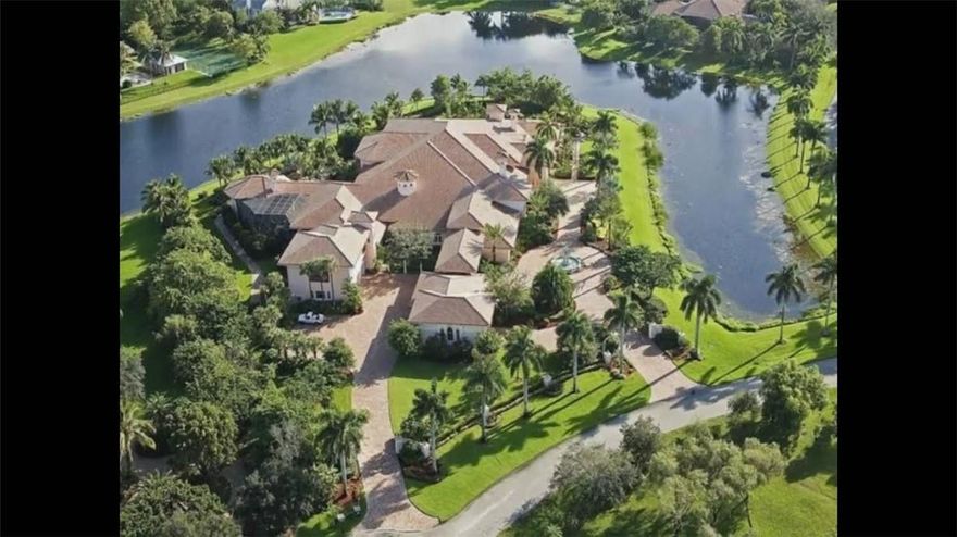 This house has been VIRTUALLY RE-STAGED with before and after photos. Custom-built palatial mansion in prestigious Windmill Ranch Estates sits as the largest home in south Florida at 34,000 sq. ft. on four acres of lush land. Beyond the entry you are greeted by an impressive spouting marble fountain that sets this property apart. The Italian inspired grand portico and 20’ massive custom wood doors are fit for a royal family!  A dramatic foyer and entry into a 6,000 square ft ballroom/great room make this Estate ideal for any car collector or sports enthusiast (indoor basketball or a multi-lane bowling alley can be done). Two formal living rooms frame the entry foyer, with their own fireplaces and high ceilings can easily serve as library, private office or entertaining spaces. The kitchen and family room space boast an open concept plan, spacious bar, rich cabinetry and quality appliances; sure, to be the heart of the home. The outdoor entertainer’s paradise houses a gorgeous rocky lagoon style pool with numerous fountains and a second Versace inspired pool that is beautifully screened in. The summer kitchen includes a built-in bar, grill & outdoor fireplace. Regal outdoor lighting sets the mood in this elevated outdoor space you will never want to leave. A stunning Master bedroom to take it over the top. Spacious his and her closets lead to a luxurious bathroom with an onyx clad walk-in shower that wraps around the elevated jacuzzi tub. With 7 additional bedrooms (each with in-suite baths), an opulent movie theater, dining room with capacity of 24 and butler’s side service, wine/billiards room, & more, this property will satisfy your every desire!  Off of this mansion, you find a 3-bay collector’s garage with a 2-bedroom private guest apartment that has a kitchen and living space. Porte cochere side entrance for ease of use connects you to a 2-car garage and attached limo garage with ample storage that make this space both functional and beautiful. Family living at its best, there is enough land on property to develop an outdoor tennis court, basketball court and/or golf recreational area. Built in 2008, this estate has yet to be occupied and is ready to be a home.