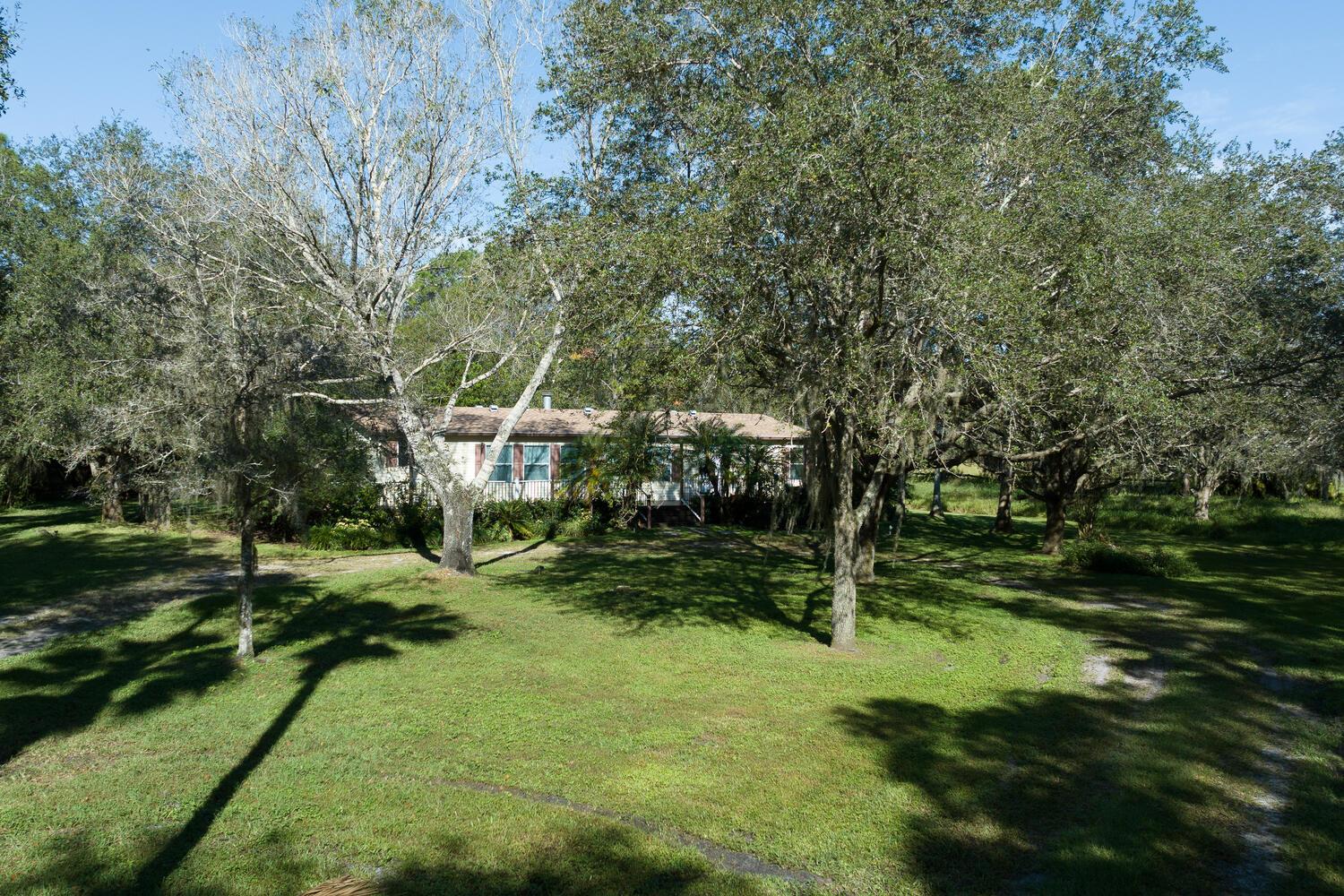 Rarely available 15+ Acre property in the Highly Desirable Community of Jupiter Farm. A Beautiful and Tranquil Family Compound Building Opportunity!! The existing 3 bedroom 2 bath house could be used as temporary housing while building your ''Dream Home'' or for caretaker's use. The Possibilities are endless including Agricultural and Equestrian. The stunning grounds have various vegetation including orange, star, and lychee fruit trees. One of the Best Locations in the Farms with quick & convenient access to Indiantown Road, Pine Glades Natural Area, Riverbend Park, Highways, Shopping and Stunning Jupiter Beach. Don't miss this opportunity to own your Piece of Paradise!!!