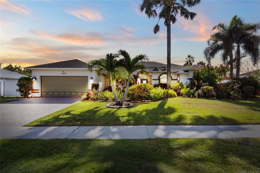 Welcome to an opportunity to own a luxurious 4-bed, 3-bath waterfront estate where refined living meets boating lifestyle. This residence delivers privacy, upgrades, and direct water access—w/out HOA restrictions. 90ft of waterfront, new poured concrete seawall and a private dock with premium composite decking. Electric boat lift accommodating vessels up to 25ft. Only one fixed bridge, easily navigable with a T-top, to enjoy access to open waterways. Inside,upgrades include a new roof and new A/C system (2024),a water filtration system and garage has an electric vehicle charging port. A screened lanai overlooks the water and a heated inground pool powered by rooftop solar panels,separate hot tub-perfect for serene evenings. Grounds has mature fruit trees,creating a tranquil, private oasis.