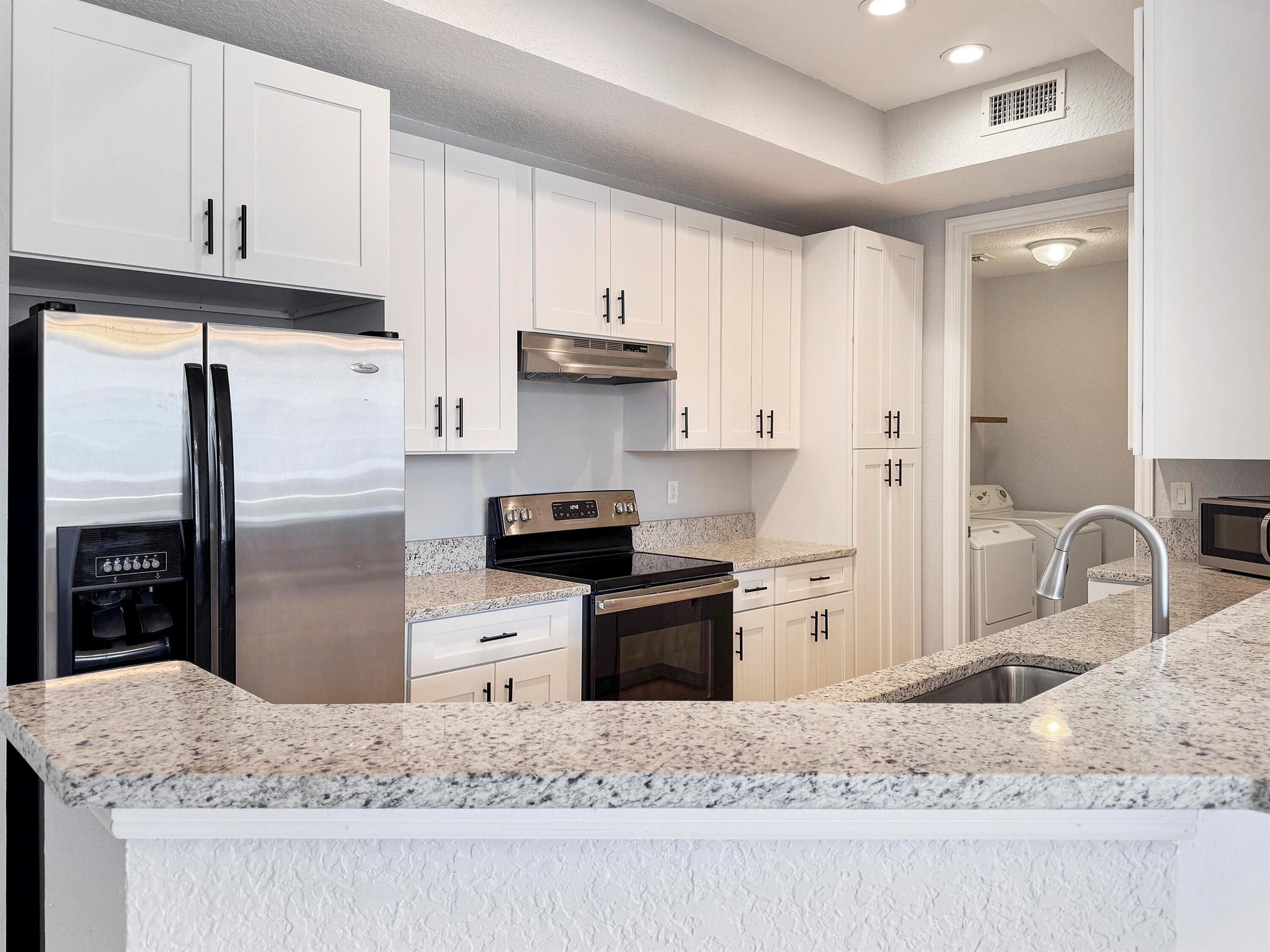 Updated kitchen with granite counters, soft close cabinets, luxury vinyl plank flooring, and fixtures. 2 bed/2 bath condo with attached 1 car garage, and full size washer and dryer in laundry room. There are 2 patios. One off of the living room and the other outside of the owner suite. The owner suite features a walk in shower and separate large tub. Two walk in closets in the owner suite as well. Located across the street from Tradition Square which features numerous shops and restaurants, all within walking distance.