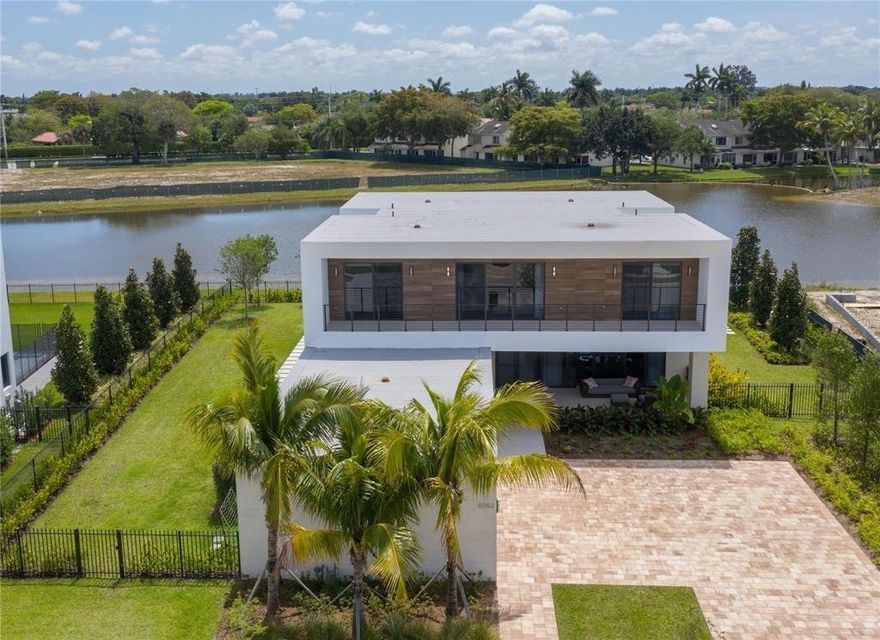 Welcome to the areas, only Exclusively Modern & Gated Communities. Designed by Chad Oppenheim, this rare private home sits on an oversized lot with lake and preserve views. The comfort of traditional South Florida indoor/outdoor living with a contemporary appeal. A desirable Open Concept Floorplan, entertaining guests, Office/6th bedroom, enormous resort style pool, covered patio and summer kitchen, all bedrooms have en-suite bathrooms, High-end finishes throughout, custom Italian cabinetry, Sub-Zero 48" fridge and Wolf appliances, Chefs Kitchen w/gas cooking, imported stone countertops, Calacatta Tile & Oak Hardwood Floors. just 1 of 69 homesites behind the South Gate.