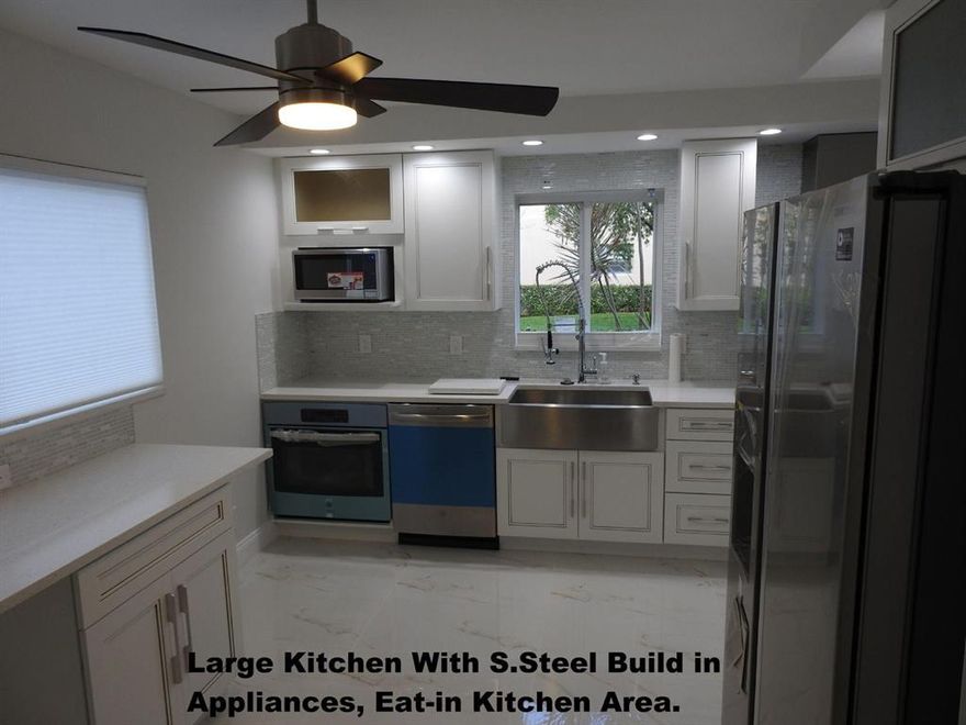 WYNMOOR 55+ COMMUNITY, MOVE IN READY! 1,450 SQ, 2/2 SPACIOUS CORNER 1st floor, lake view, walking distance to pool, NEW impact windows, glass enclosed patio. REMODELED-IMMACULATE TOP-OF-LINE DESIGN(never occupied after renovation) all wood custom EAT-IN Kitchen w/ new. s.steel build in Appliances. (glass cooktop), quartz counters, mosaic backsplash. costume shelving closet organizer in every closet. W/D inside unit, New solid wood glass doors. 32'' porcelain tile throughout, new 5 1/2'' baseboard. FRESHLY PAINTED. (CEILING-NO POPCORN). NEW: ceiling fans, lights, window treatments. top of line kitchen & bath faucets. master & guest bathrooms fully renovated. 14'' deepest tub, 1 shower ( frameless 3/8 shower glass), all wood custom vanities, new one-piece toilets. ALL RENOVATION WORK DONE W/ CITY & ASSOC PERMITS!!! WYNMOOR-all amenities of an adult 55+ community.