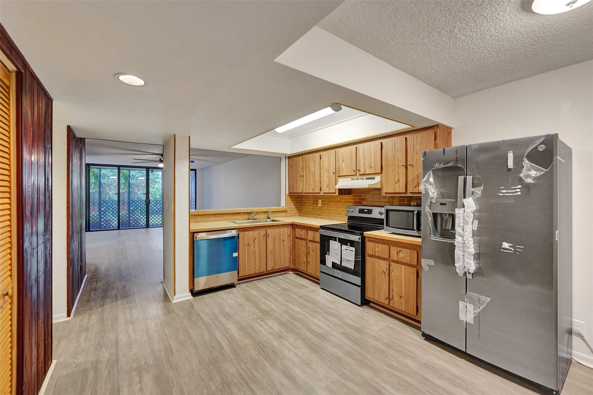 Welcome to your newly updated home, perfectly situated just minutes from major highways and schools such as Nova Southeastern University and Broward College. This charming condo features fresh renovations throughout, including brand-new appliances, updated shut-off valves on all water lines, and stylish new ceiling fans for added comfort. Enjoy the convenience of an in-unit washer and dryer and relax in your private screened-in patio or one of two front open areas. The condo boasts a decorative wood accent wall. Vinyl flooring throughout. Community offers a tennis court, pool, lake with a dock to sit on and soak in the sun and a clubhouse that can be rented for events. Great investment property, can rent out right away.