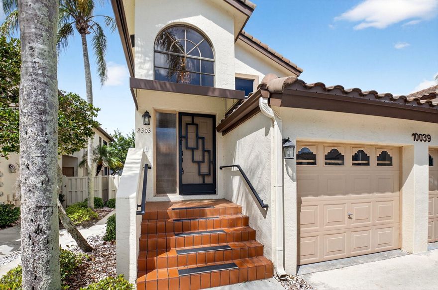 This light, bright, and airy corner coach home features soaring ceilings that create a spacious, open feel throughout. The home offers 2 bedrooms plus a den/convertible 3rd bedroom, a 1-car garage, and a wall of windows that fills the space with natural light. The large primary suite features vaulted ceilings and skylights, while the living areas are finished with new driftwood-style engineered wood flooring. New Roof, Relax in the Florida Room overlooking the canal, where you can enjoy the comfort of A/C or open the sliding doors to let in the cool southern breezes. Located in the gated community of Banyan Springs, residents enjoy a very active clubhouse with an indoor/outdoor café, grand social hall, fitness center, beauty salon, tennis with an on-site pro, and active pickleball teams.