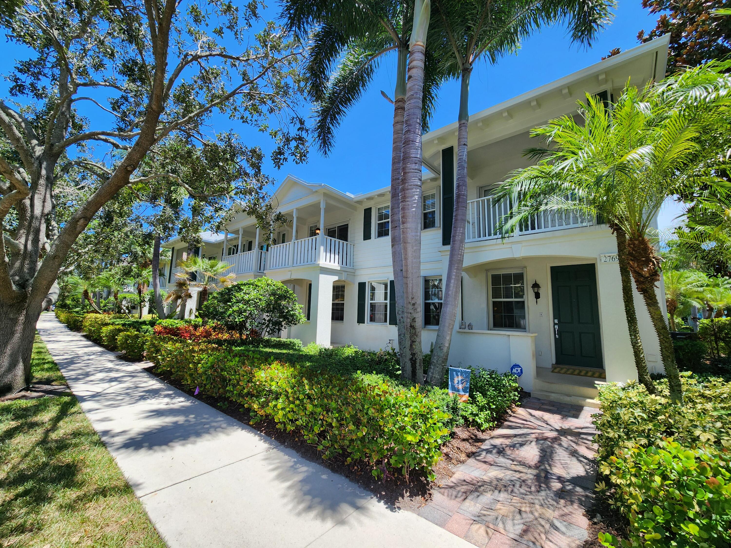 Welcome to this inviting 3 bed, 3 bath, 2-story townhouse located in the desirable Martinique community of Abacoa. Situated as an end unit, this home offers ample green space in the rear and side yards, plus, two front porches, providing a private and tranquil setting. Upon entering, you are greeted by a bright and open floor plan featuring high ceilings and a freshly painted interior. The first floor encompasses an adaptable space with brand new wood flooring throughout, complemented by a full bath nearby. The spacious living area seamlessly flows into the dining and kitchen areas, perfect for both casual family meals and entertaining. Step outside to enjoy the screened-in lanai, ideal for year-round entertaining and relaxation. Brand new roof installed 2024.