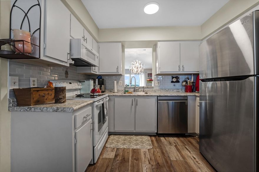 Lovely condo in the heart of Huntington Lakes. South facing unit. Section pool and nice patio right downstairs. Beautiful flooring throughout. Updated kitchen. stainless steel appliances. Large and bright living-dining area. Step out to the long lanai w/serene direct pond and lake view. Two large bedrooms and 2 updated bathrooms. Smooth ceilings. No popcorn. Stunning condo. There is a special assessment that will be paid by the seller.  Huntington Lakes clubhouse is gorgeous!! Recently renovated. Very active 55+ clubhouse. Many clubs, activities, sports, indoor pool, 630 seat full theater. for shows and movies. 350 seat banquet room, card rooms, billiards, weight and aerobic room, x-large indoor pool, spa, sauna. Very active sports facility. Pickleball, Har Tru tennis, paddle tennis.