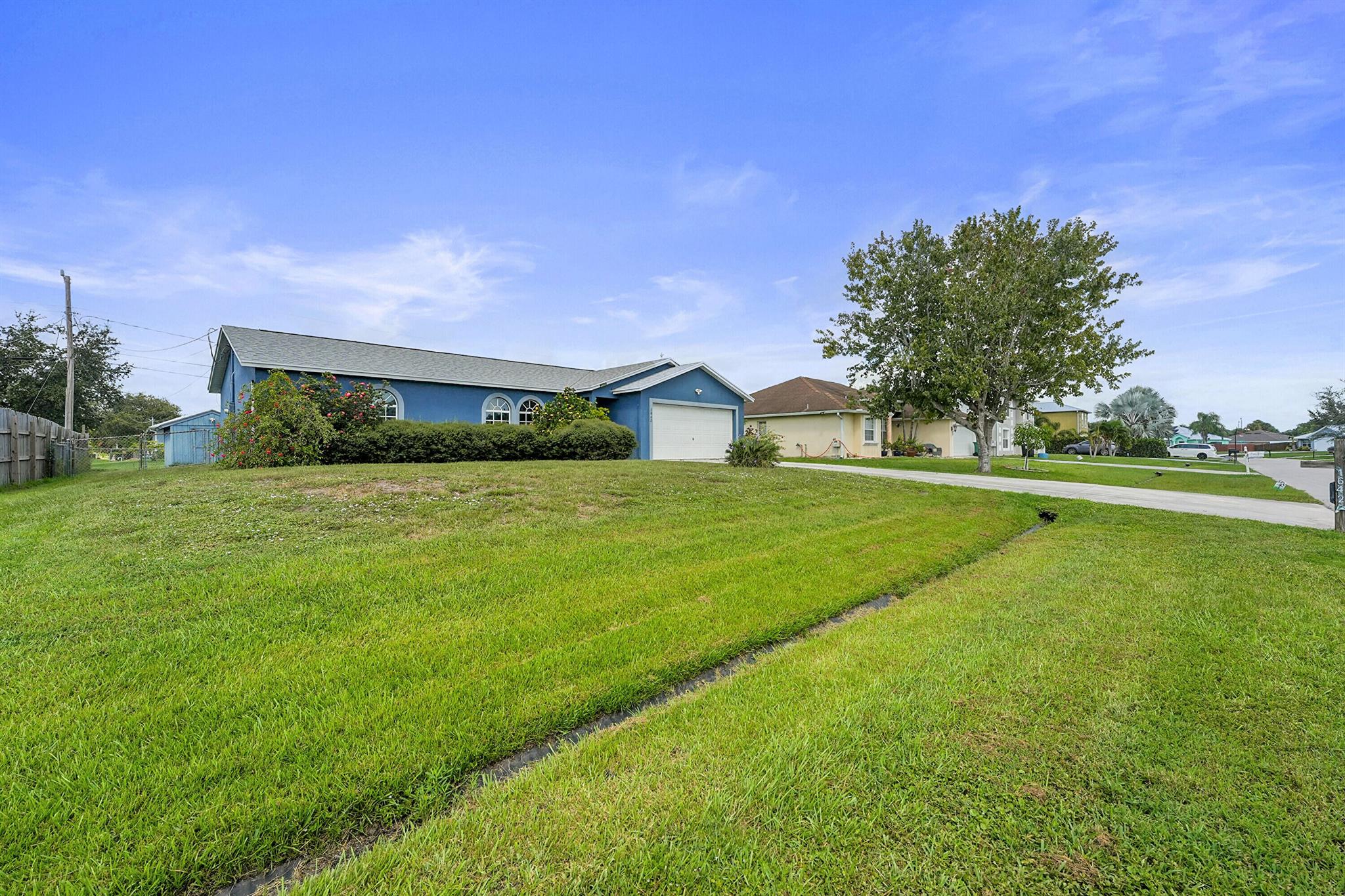 Welcome to 3BR/2BA ''CBS'' home with 2-car garage and a long driveway perfect for extra vehicles or toys. Enjoy peace of mind with a 2023 ROOF and a spacious open split floor plan featuring an island kitchen with granite countertops, stainless steel appliances, and plantation shutters. Relax on the screened patio overlooking the fenced yard with utility shed. Ideally located near I-95, Crosstown Parkway, Tradition'downtown's shops and dining, Walmart, Publix, Target, TJ Maxx, restaurants, and hospitals.