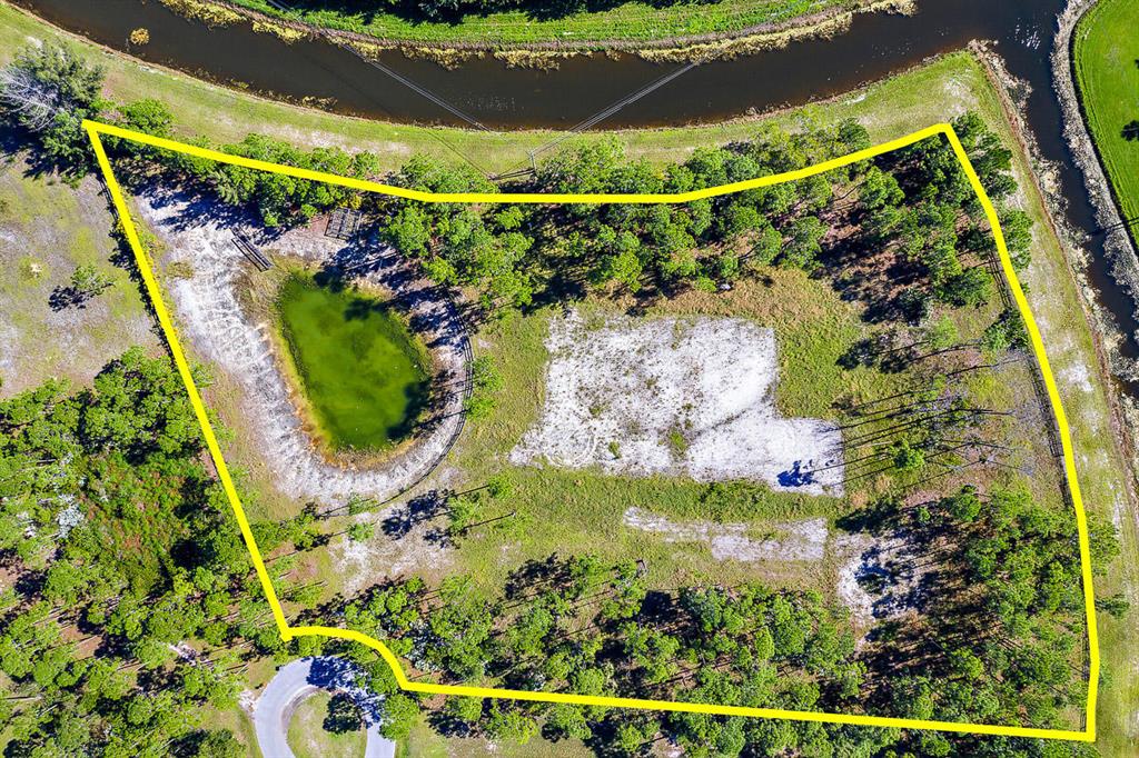 Now is your chance to own a premium 5 acre lot with optimal privacy set at the end of a cul-de-sac, with a 10,000 sqft building pad ready for your dream home. This property is fully fenced and cleared, with an irrigation pond offering sustainability. Caloosa is a pristine community near all that Palm Beach Gardens has to offer, yet provides a feeling of privacy and serenity. 30 miles of bridal trails to enjoy, along with a 32 acre equestrian park, basketball & tennis courts, playground, and club room.