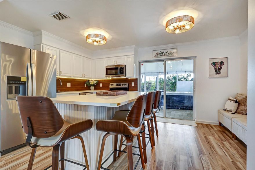 Licensed owner lists this turnkey, meticulously remodeled NO HOA home in a quiet, family-friendly area. Enjoy an expansive screened porch with a heated Wellis spa—a private, intimate oasis backing onto lush greenery with no rear neighbors. Features a laundry room & extra spaces (larger than public records). Private well with full filtration/softener. AC 2024, Roof 2016, new 2026 impact front door. Impact-rated windows or AstroGuard protection. Minutes to I-95, PGA corridor, CityPlace & beaches. Move-in ready or rental income canvas—sold fully furnished. Sold AS IS. All measurements are estimates; buyer to verify. Priced as a lifestyle/income asset. Buyers encouraged to have cash reserves to bridge any potential appraisal gap. See Broker Remarks.