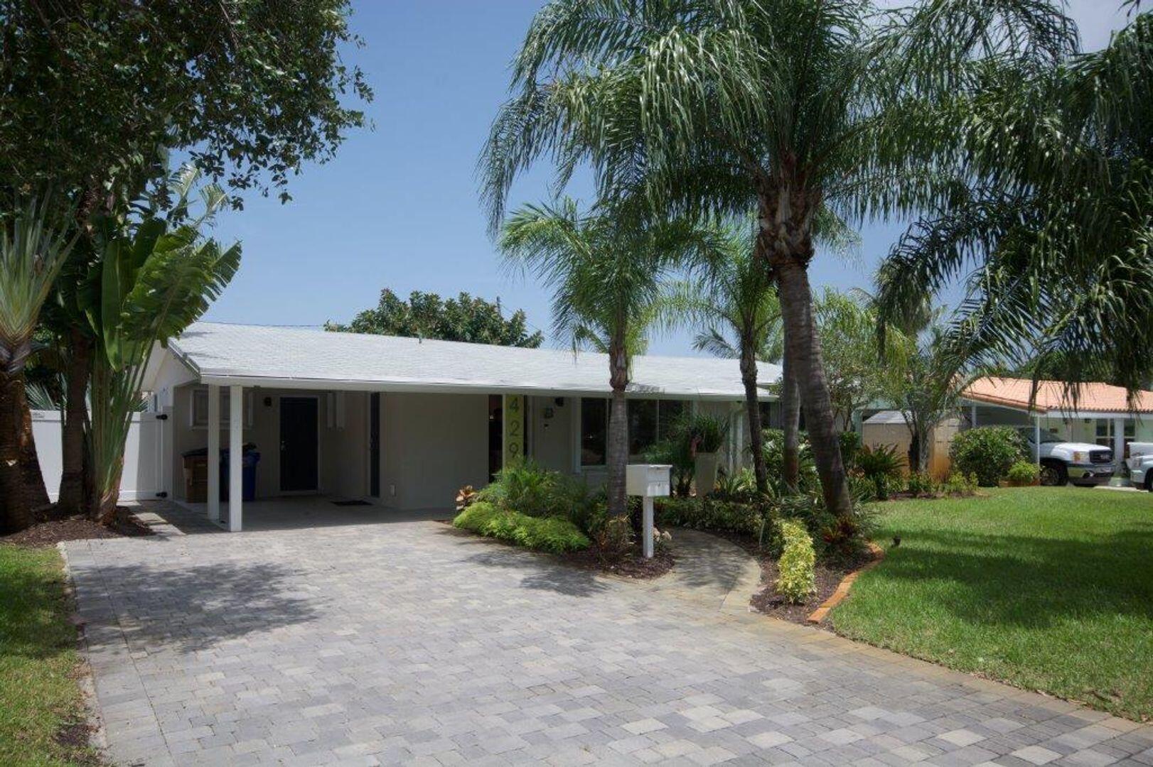 Step Into Sunshine: Modern Charm Meets Coastal Cool - Fully Furnished!A charming tropical retreat nestled in the heart of East Deerfield Beach, this stylishly updated 3-bedroom, 2-bath home perfectly blends comfort and sophistication. From the sleek, open-concept layout to the custom wine cabinet and designer lighting, every inch is thoughtfully curated for modern living. The spacious kitchen boasts stainless steel appliances and upgraded finishes, flowing effortlessly into the sunlit dining and living areas--ideal for entertaining, family gatherings, or simply relaxing in style. Outside, your private paradise awaits with a HEATED saltwater pool, expansive travertine patio, and lush landscaping surrounded by solar privacy fencing. Grill up a feast in the outdoor kitchen, unwind under the