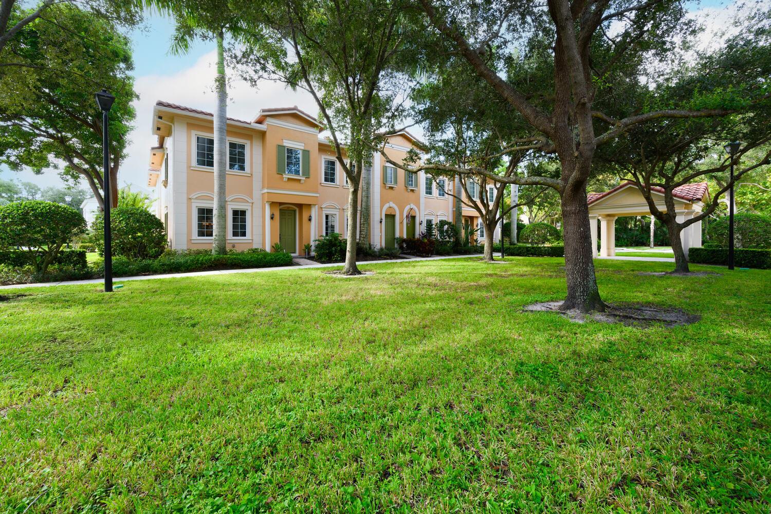 Stunning end unit townhome in beautiful Jupiter, FL. This bright and airy residence boasts soaring volume ceilings, impact glass throughout, and an open concept design bathed in natural light. The main home features 3 bedrooms and 2.5 baths, complemented by a private 1 bedroom, 1 bath guest suite or office with a kitchenette. Perfect for guests or remote work. The eat-in kitchen is a chef's dream, showcasing elegant wood cabinetry, stainless steel appliances, and granite countertops. The expansive great room flows seamlessly to a serene private courtyard and an attached 2 car garage. Upstairs, the primary suite offers a walk in closet, a spa inspired bath with dual vanities, a large shower, and a soaking tub. Two additional bedrooms and a convenient upstairs laundry on the 2nd floor.